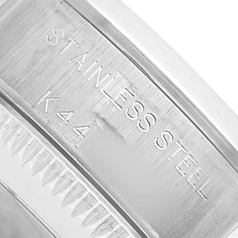 The image shows a close-up of the case back edge of a Rolex Oyster Perpetual 76080 Women's Stainless Steel Silver Dial, highlighting the "STAINLESS STEEL" engraving.