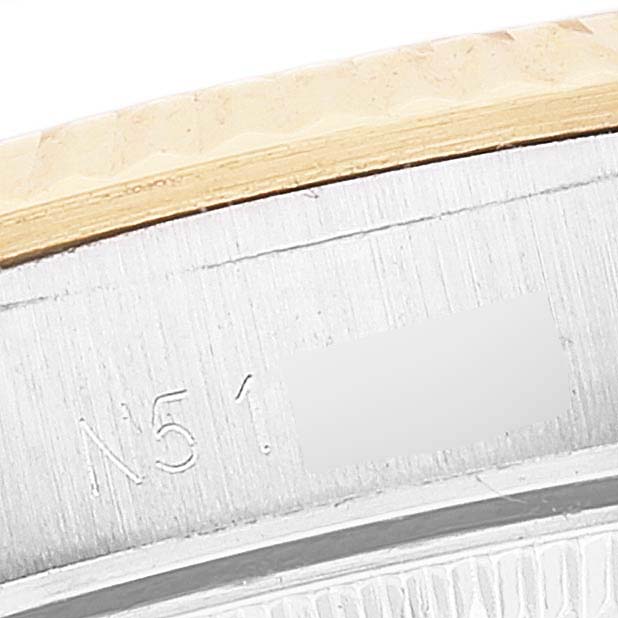 This is a close-up image showing part of the bezel and caseback of a Rolex Oyster Perpetual 67193 Women's Steel and Gold (two tone) Champagne Dial 67193 Women's Steel and Gold (two tone) Champagne Dial watch.