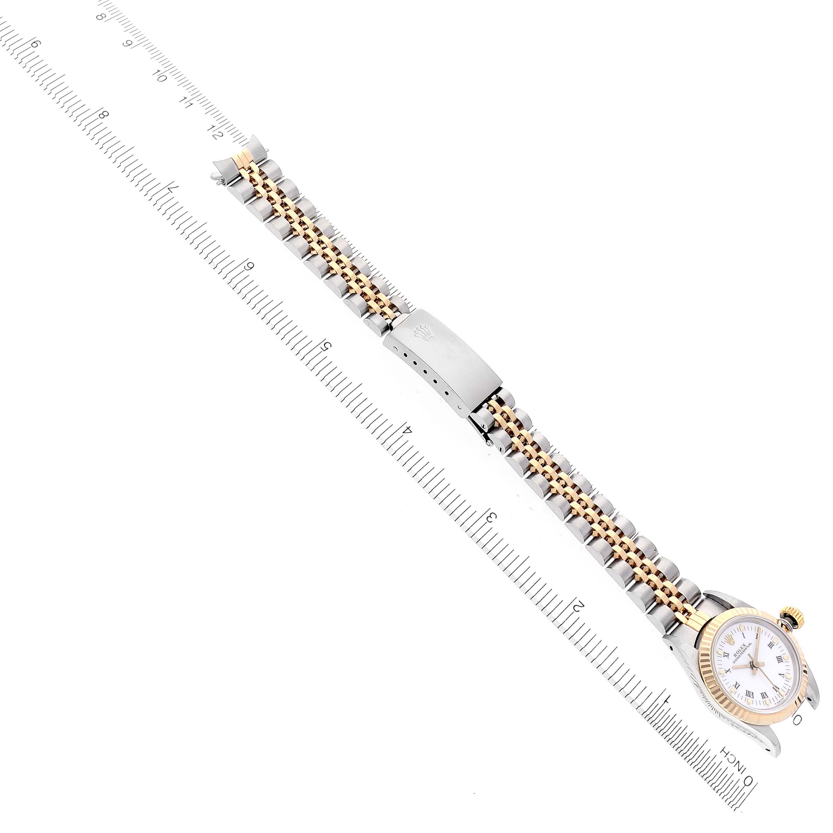 The Rolex Oyster Perpetual 67193 Women
s Steel and Gold (two tone) White Dial 67193 Women
s Steel and Gold (two tone) White Dial watch is shown from a top-down angle, highlighting its bracelet and clasp.