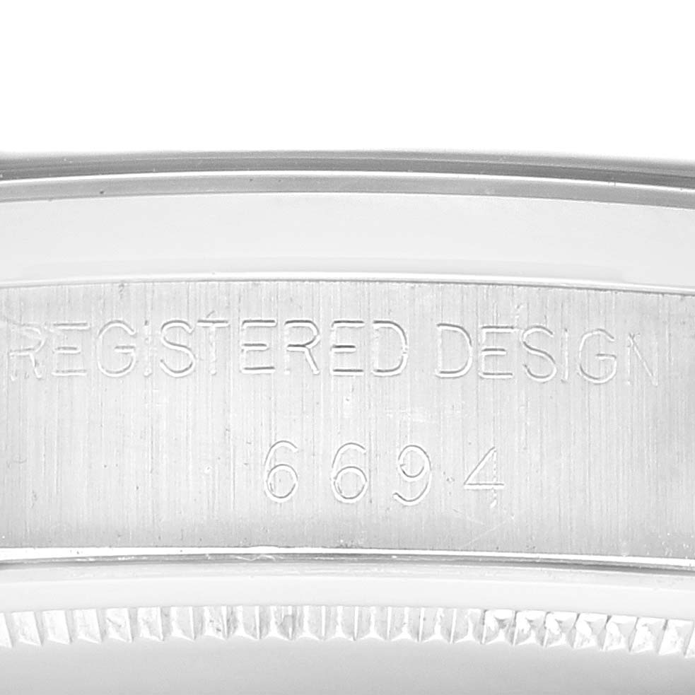 This image shows a close-up view of the side engraving on a Vintage Collection Rolex watch, featuring the model number 6694.