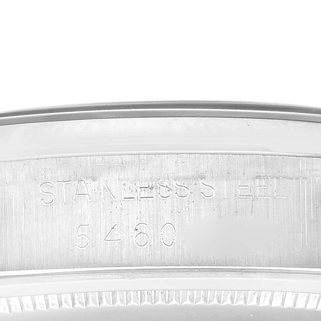 This image displays the engraved steel edge from a Vintage Collection Rolex watch, showcasing its material and partial serial number.
