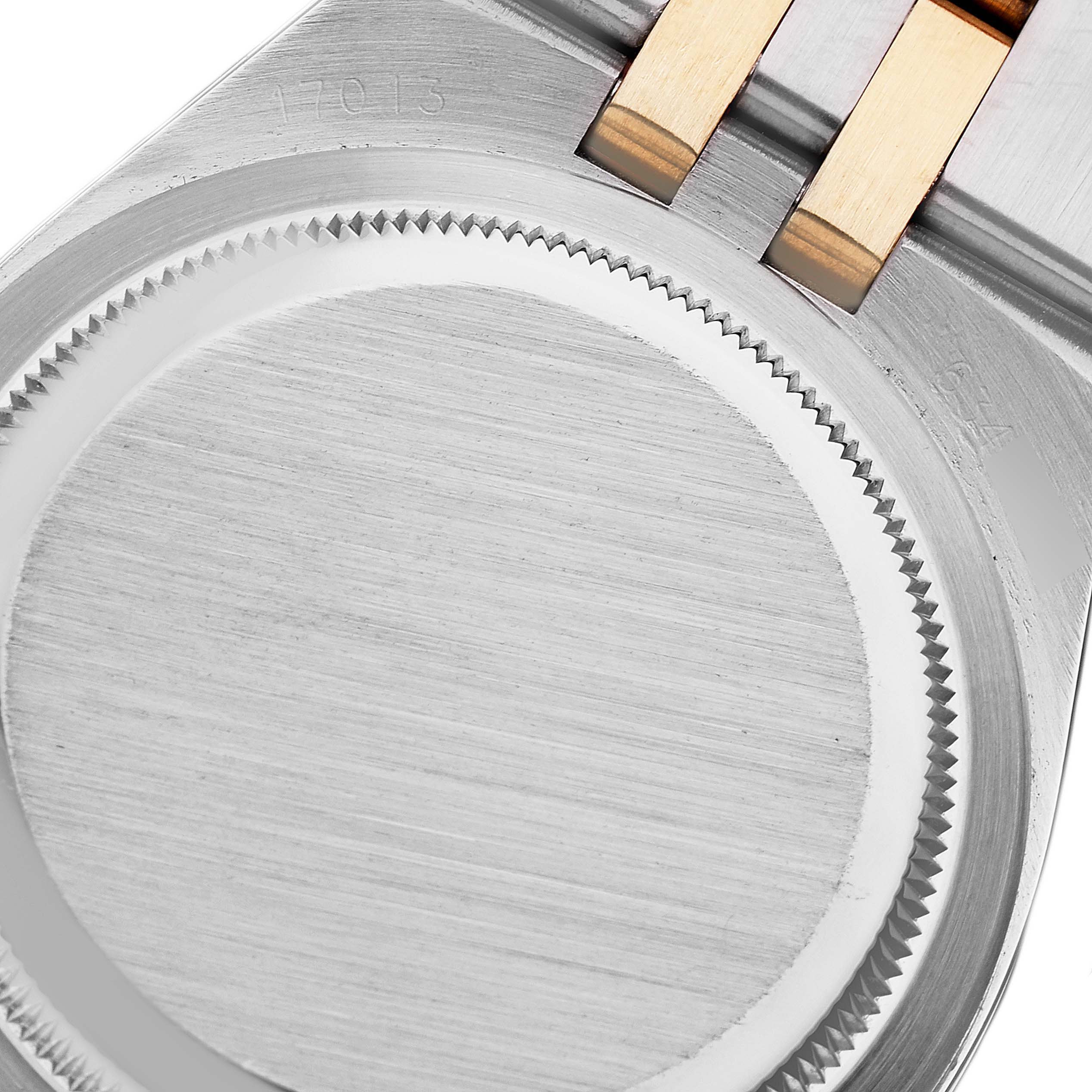 The image shows the back case and part of the bracelet of a Rolex Oysterquartz 17013 Men's Steel and Gold (two tone) Champagne Dial 17013 Men's Steel and Gold (two tone) Champagne Dial watch.