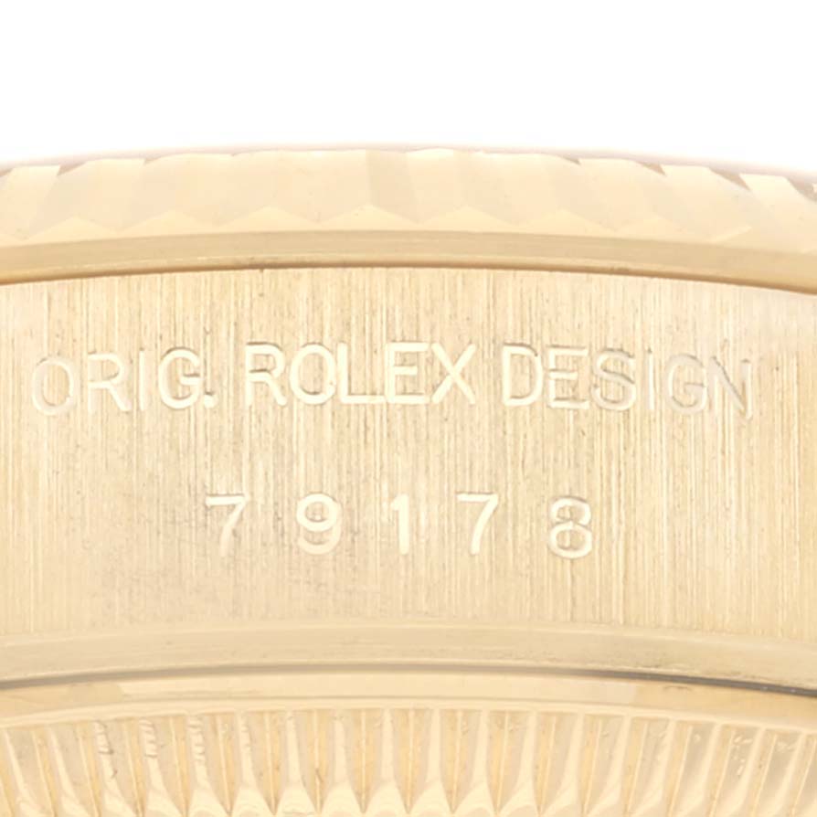 This image shows a close-up of the engraved serial number and "ORIG. ROLEX DESIGN" on a Rolex President 79178 Women's Yellow Gold Champagne Dial 79178 Women's Yellow Gold Champagne Dial watch.