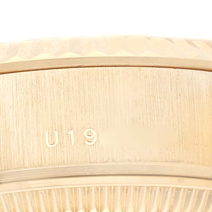 The image shows a close-up of the side of the bezel and case back of a Rolex President 79178 Women's Yellow Gold Champagne Dial 79178 Women's Yellow Gold Champagne Dial model watch with engravings visible.