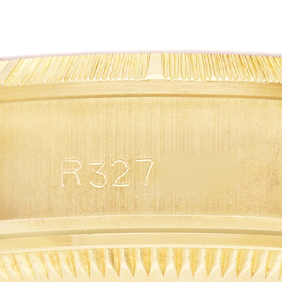 The image shows a close-up of the side engravings on the bezel of a Rolex President 69278 Women's Yellow Gold Champagne Dial 69278 Women's Yellow Gold Champagne Dial model.