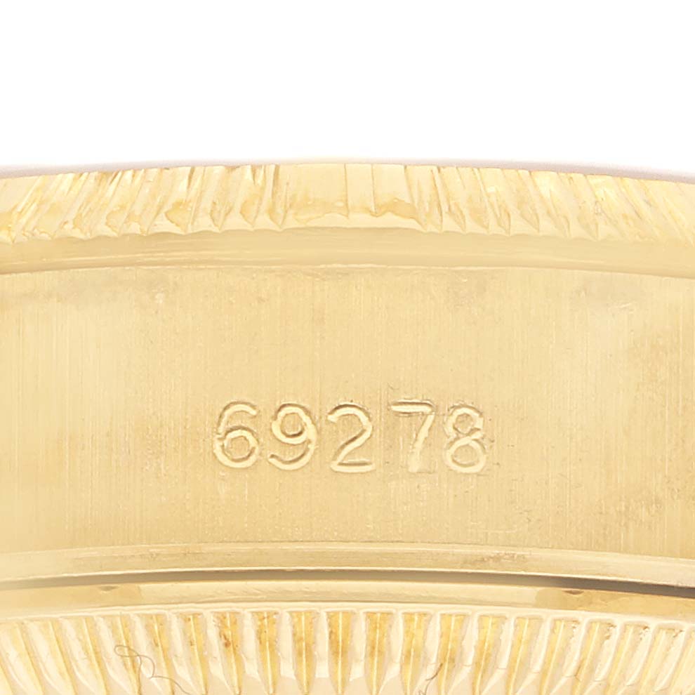 The image shows a close-up of the serial number engraved on the band of a Rolex President 69278 Women's Yellow Gold Champagne Dial model watch.