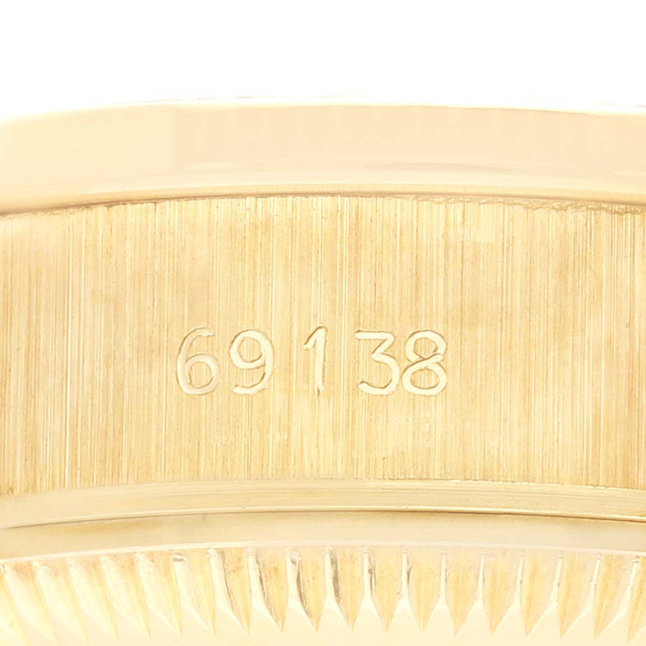 The image shows a close-up of the model number engraved on the side of a Rolex President 69138 Women's Yellow Gold Champagne Dial 69138 Women's Yellow Gold Champagne Dial watch case.