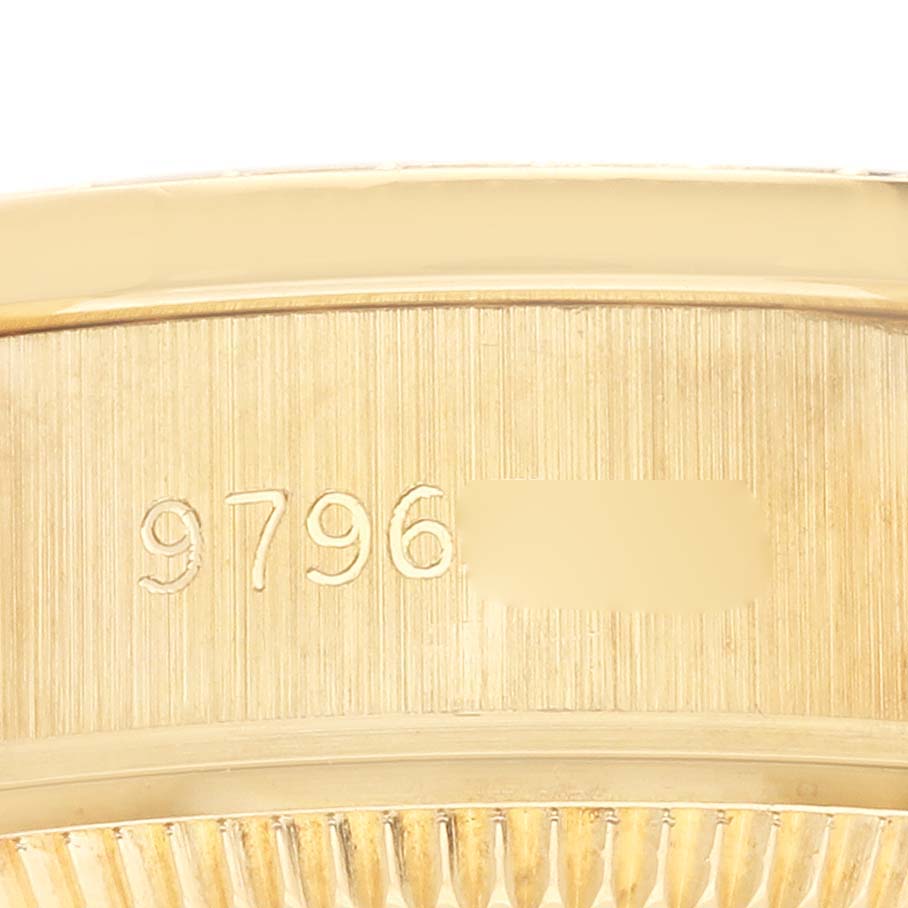 The image shows a close-up of the serial numbers engraved on the side of a Rolex President 69138 Women's Yellow Gold Champagne Dial 69138 Women's Yellow Gold Champagne Dial watch case.