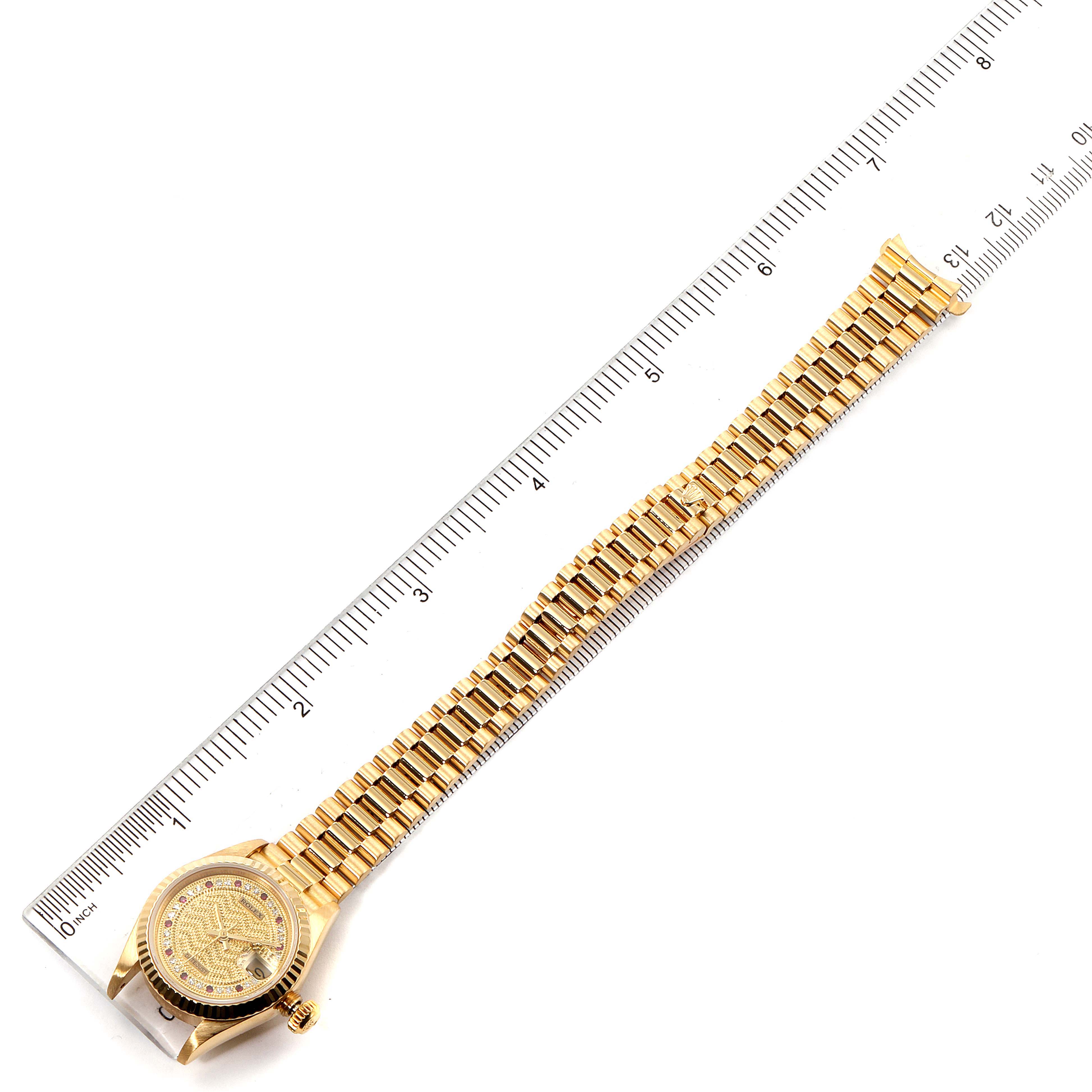 A Rolex President 69178 Women
s Yellow Gold Champagne Dial 69178 Women
s Yellow Gold Champagne Dial model watch is shown from a top-down angle, featuring its full band and Rolex-branded face.