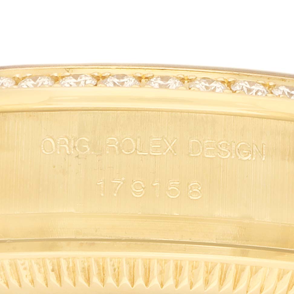 The image shows a close-up of the side of a Rolex President 179158 Women's Yellow Gold Mother of Pearl Dial watch, highlighting the "Orig. Rolex Design" engraving and diamonds on the bezel.