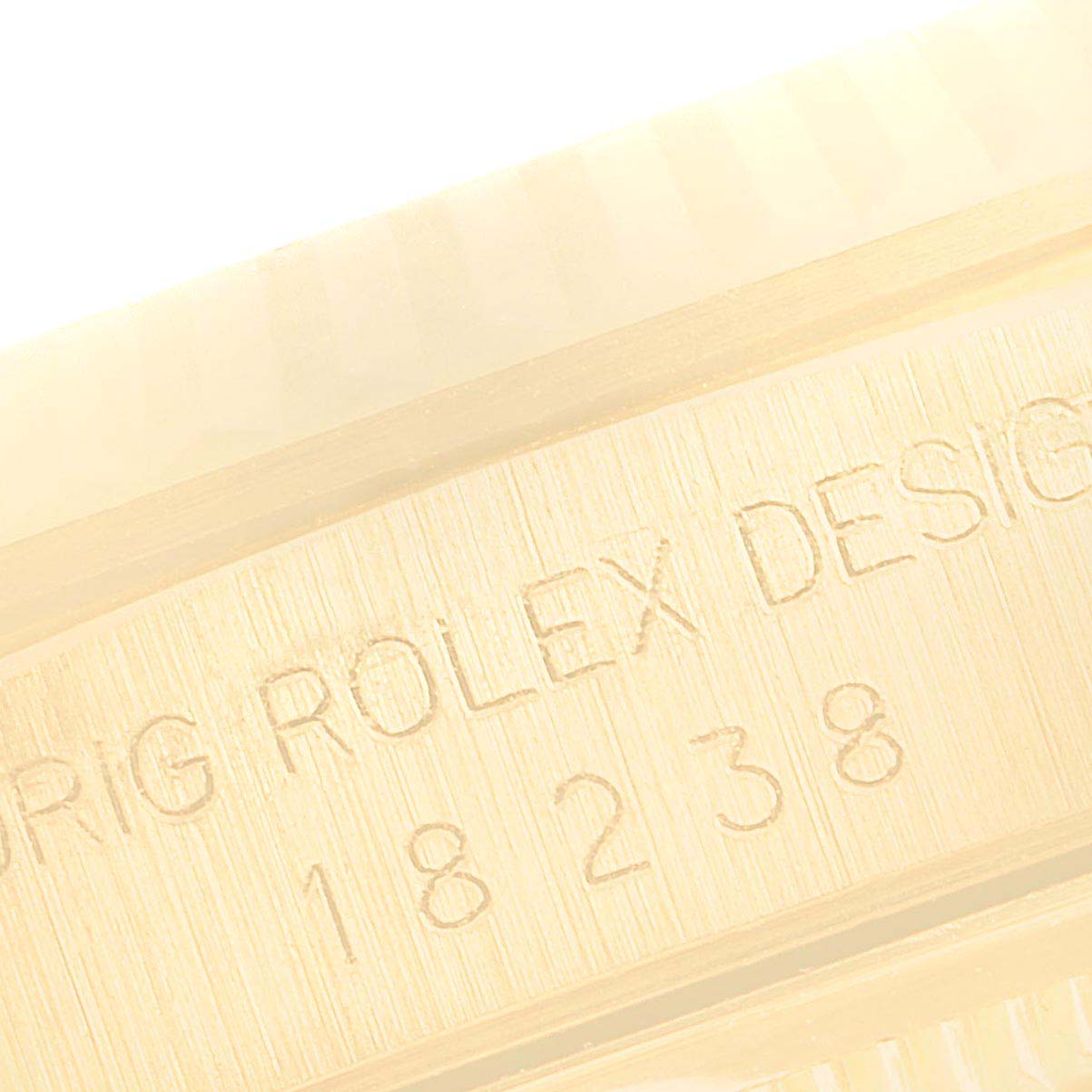 This close-up image shows the engraving on the side of the case of the Rolex President 18238 Men's Yellow Gold Champagne Dial 18238 Men's Yellow Gold Champagne Dial model watch.