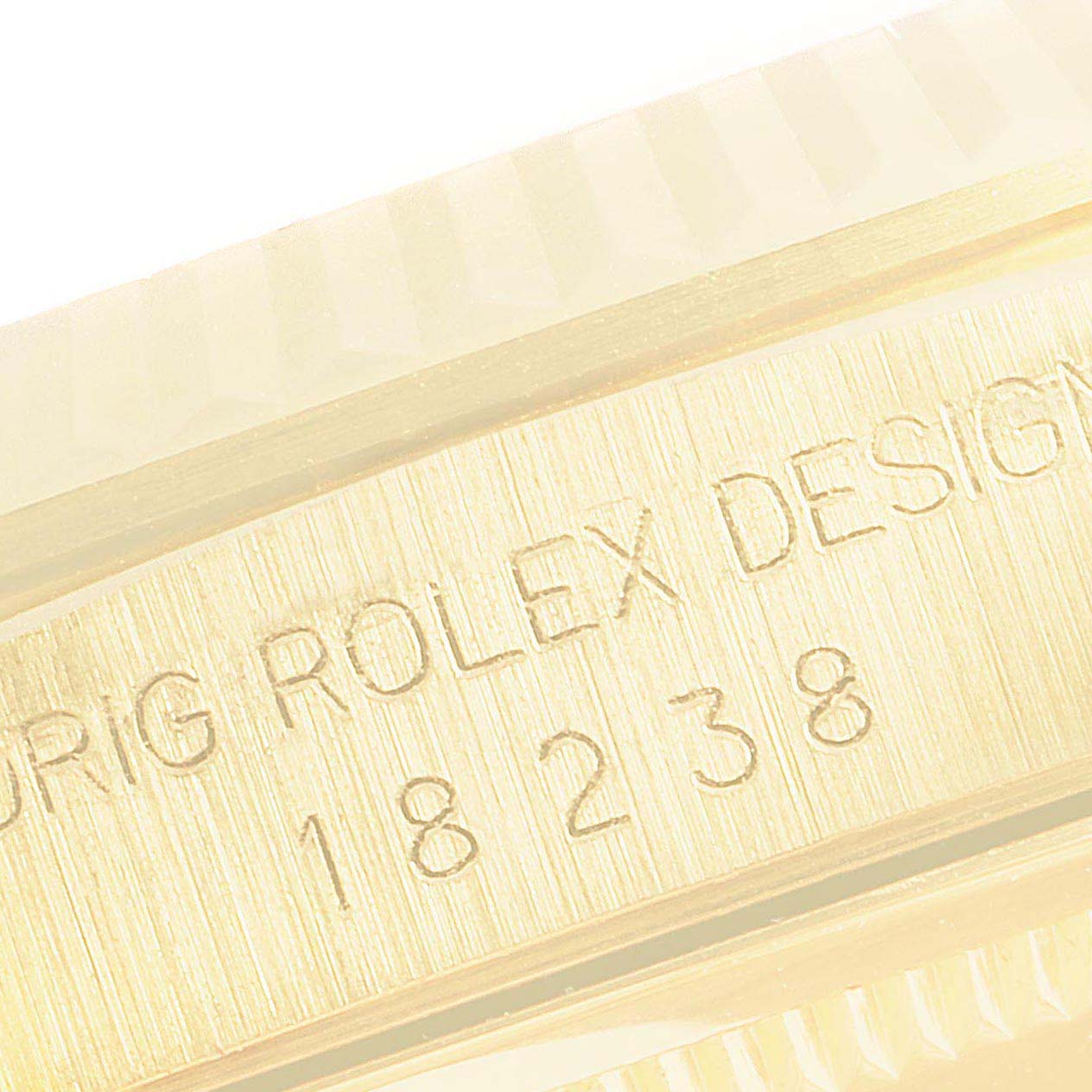 The close-up image shows the side of the case of a Rolex President 18238 Men
s Yellow Gold Champagne Dial 18238 Men
s Yellow Gold Champagne Dial model watch, displaying the engraved model number.