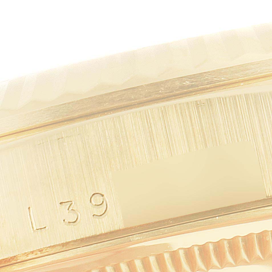 This image shows a close-up angle of the bezel and case of a Rolex President 18238 Men
s Yellow Gold Champagne Dial 18238 Men
s Yellow Gold Champagne Dial watch, displaying part of its serial number.