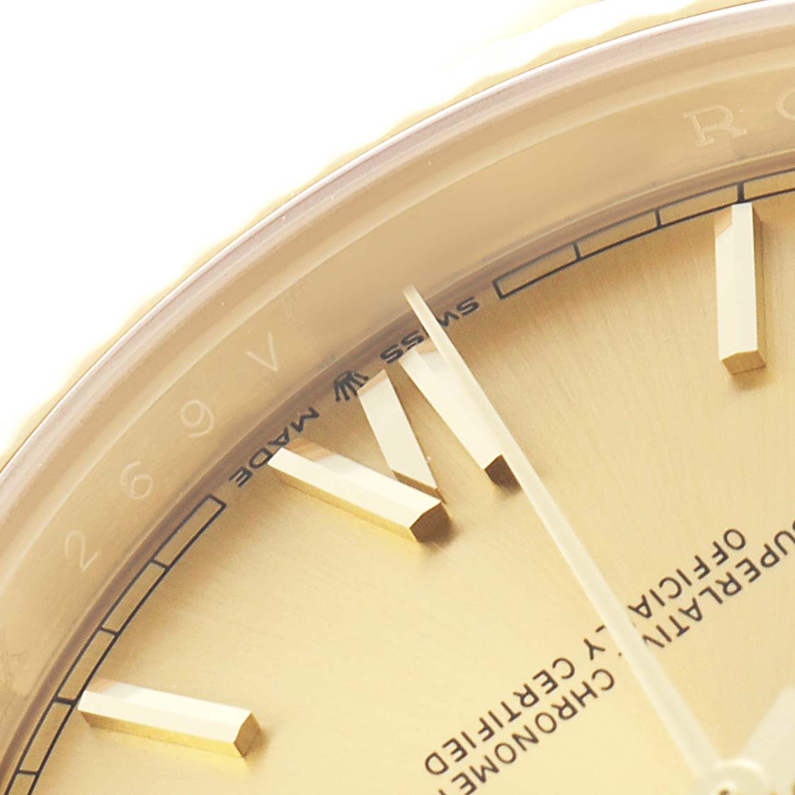 The image shows a close-up of the dial and hour markers of a Rolex President 228238 Men's Yellow Gold Champagne Dial watch at an angled view.