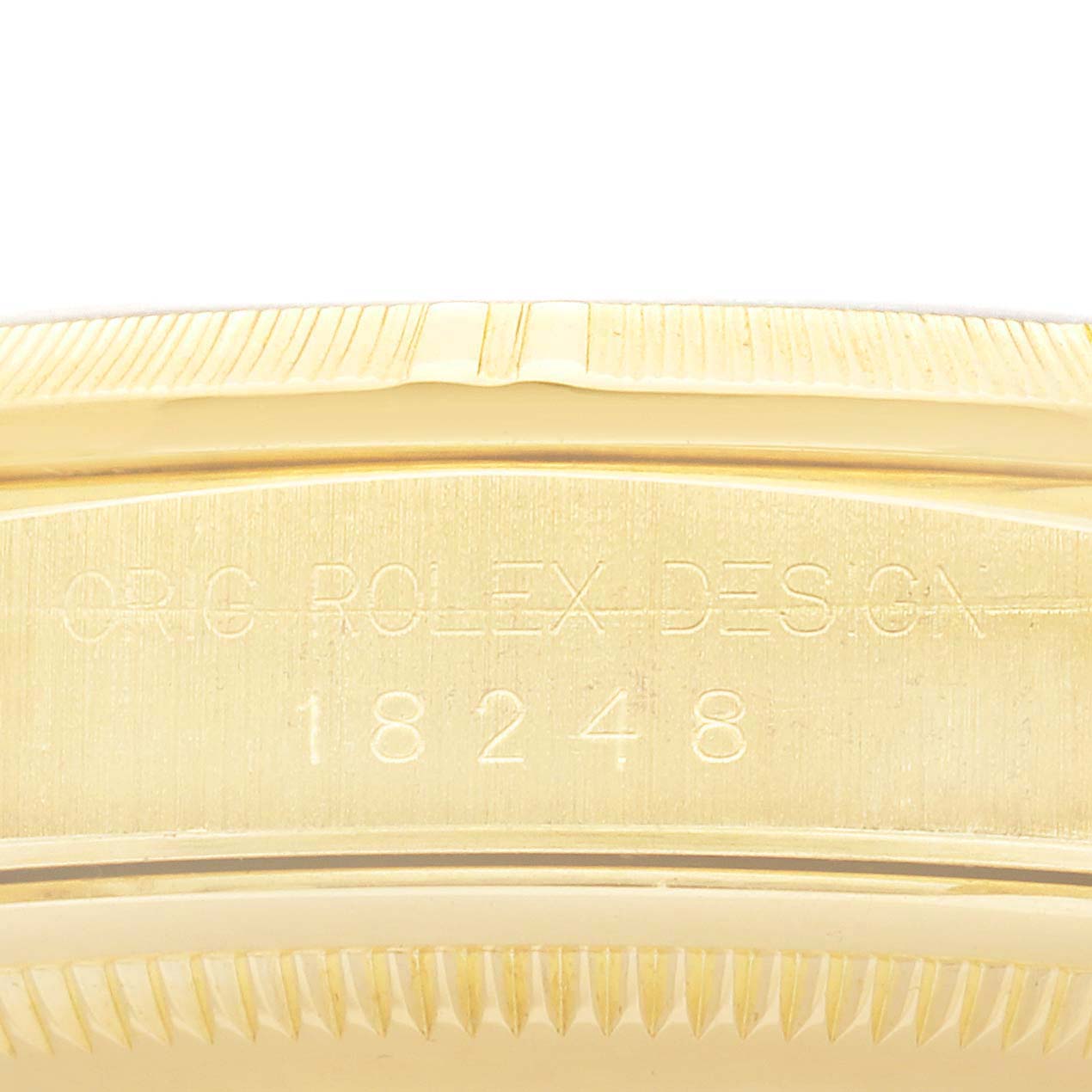 The image shows a close-up of the side of the Rolex President 18248 Men's Yellow Gold Champagne Dial model, displaying the engraved design and serial number.