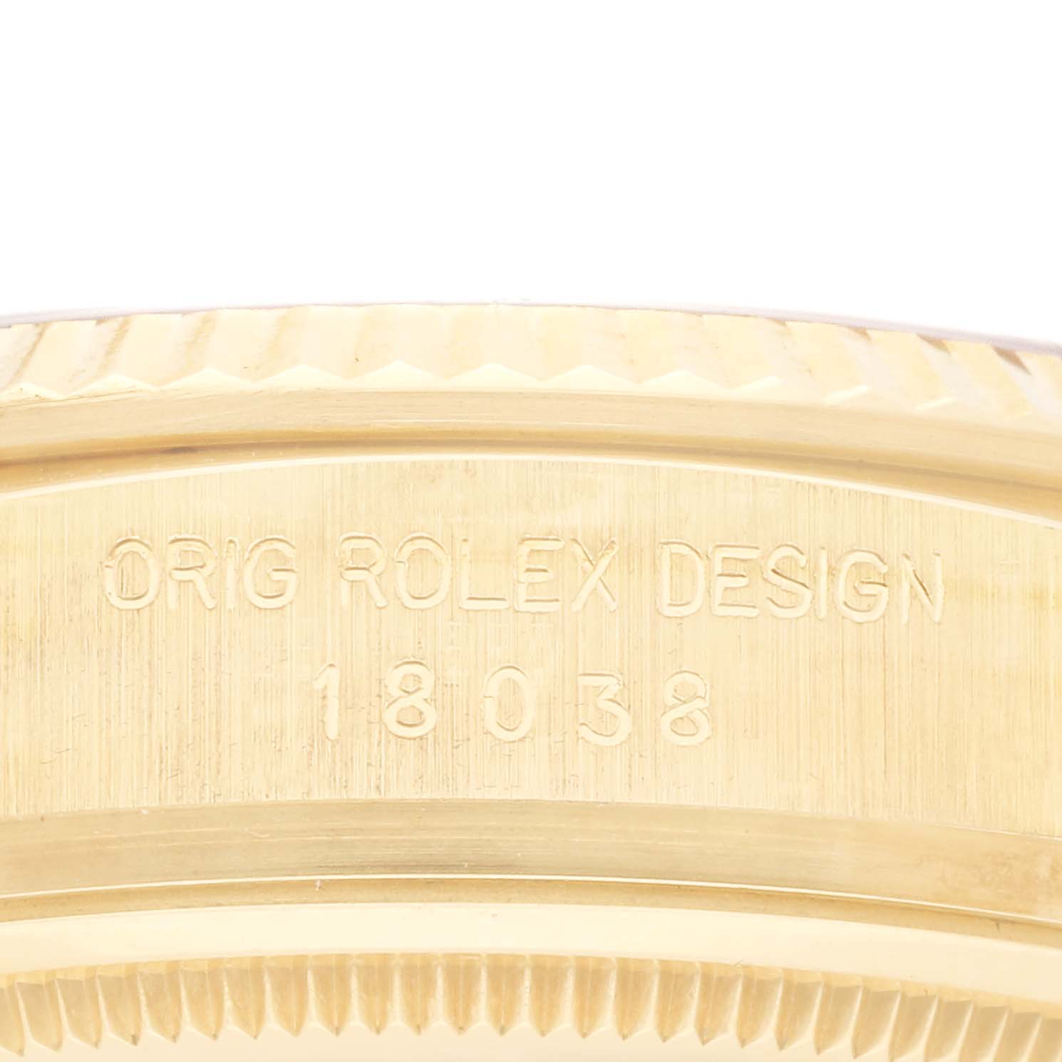 The image shows the side view of a Rolex President 18038 Men's Yellow Gold Champagne Dial 18038 Men's Yellow Gold Champagne Dial model bezel with engravings, focusing on markings.
