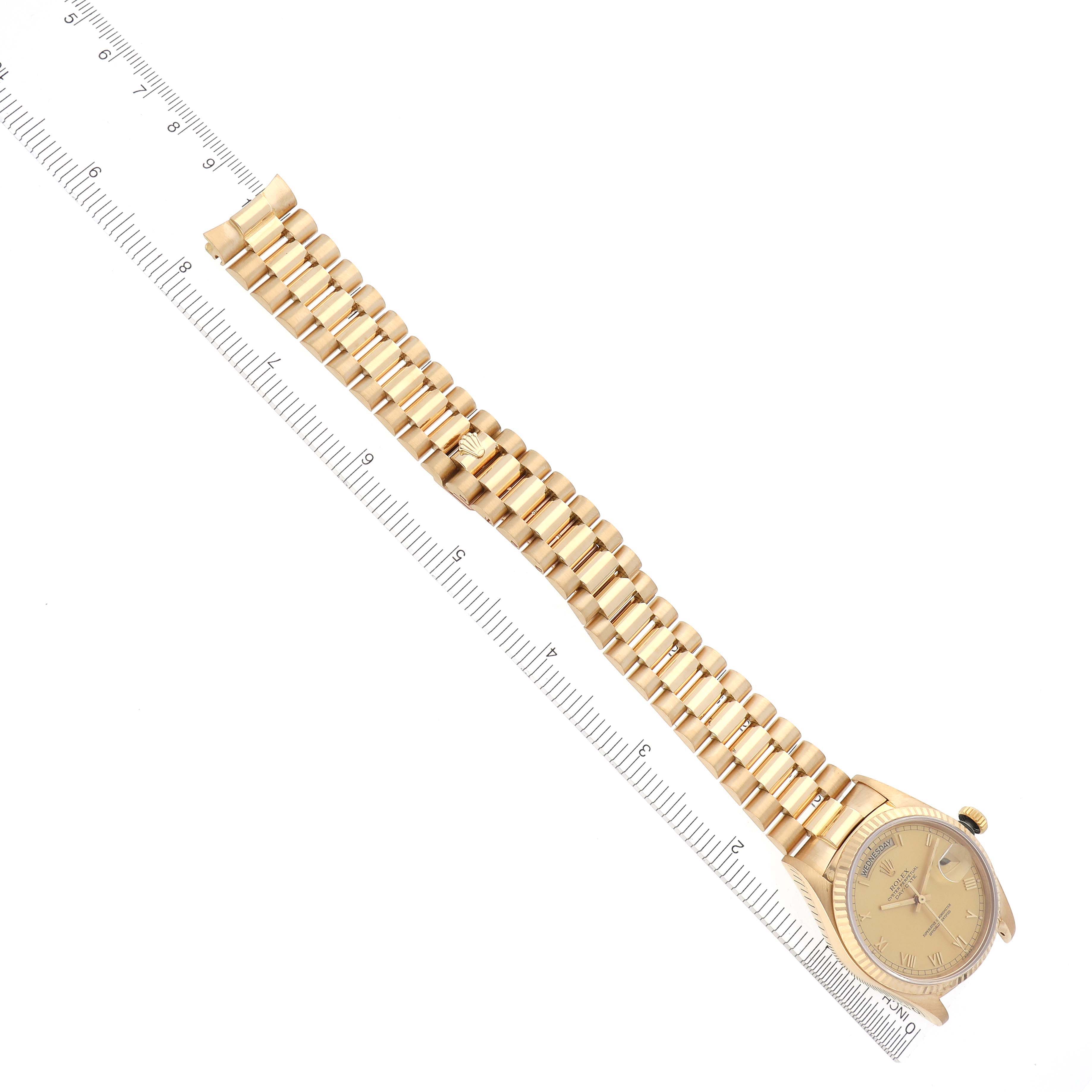 The Rolex President 18038 Men's Yellow Gold Champagne Dial 18038 Men's Yellow Gold Champagne Dial watch is shown at an angled top view, displaying the bracelet and face with accompanying ruler for scale.