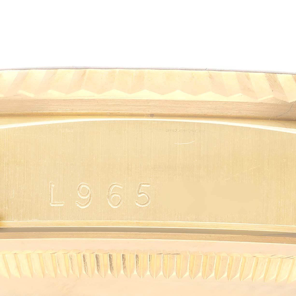 This image shows a close-up of the side of a Rolex Datejust watch, focusing on the edge engraving.