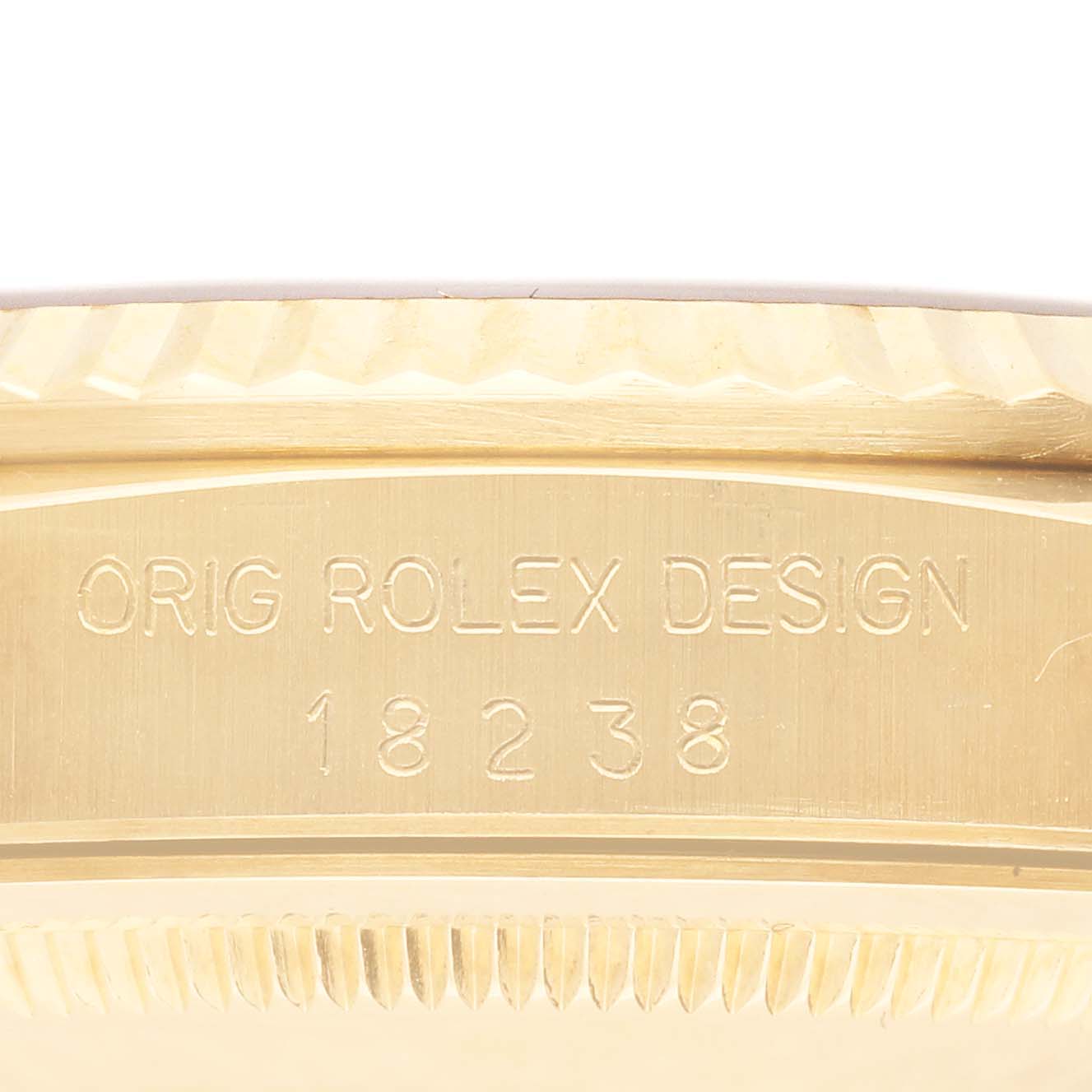 The image shows the side engraving of a Rolex Datejust model, displaying "ORIG ROLEX DESIGN" and the model number 18238.