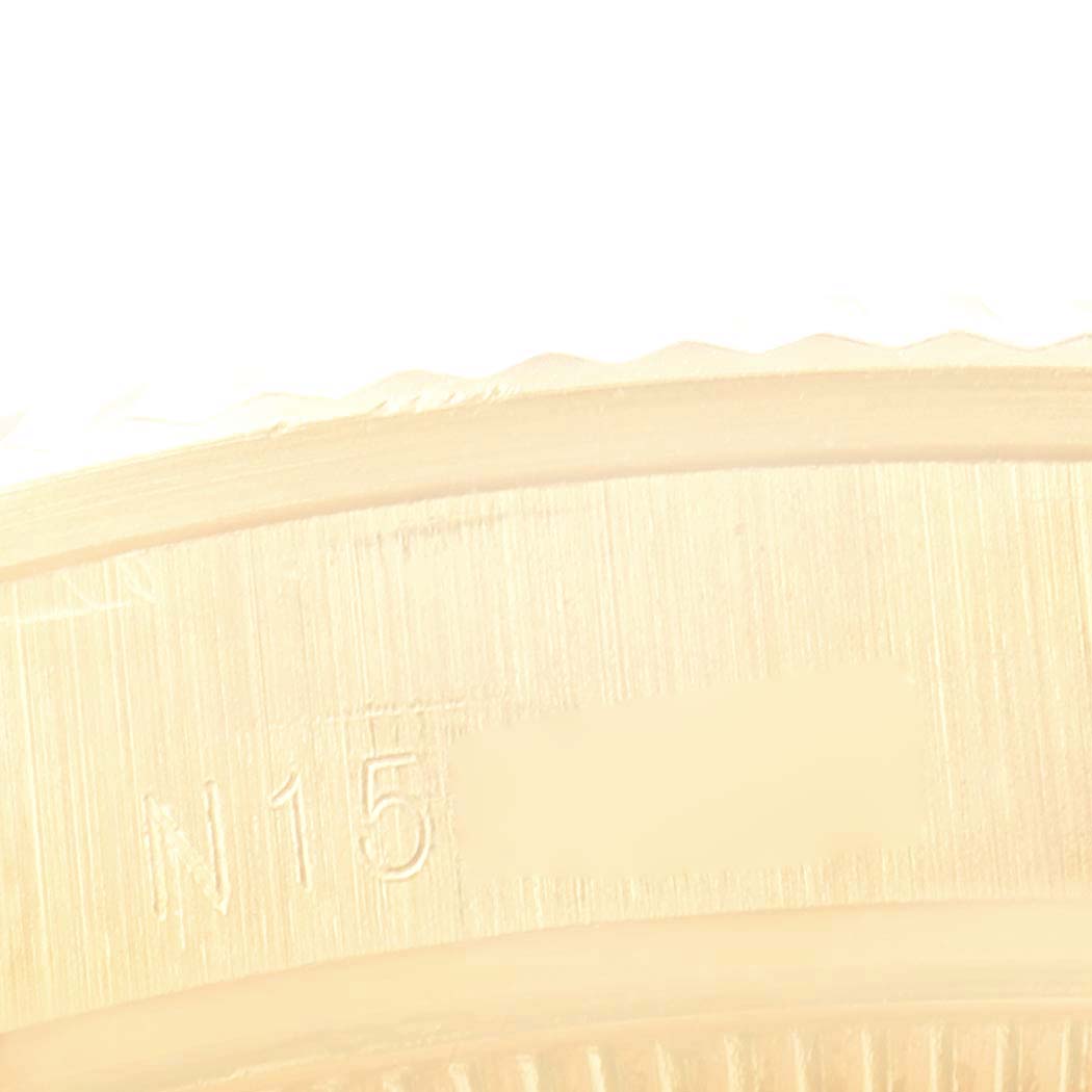 This close-up image shows the engraved inner bezel of a Rolex President 68238 Women's Yellow Gold White Dial 68238 Women's Yellow Gold White Dial model watch.