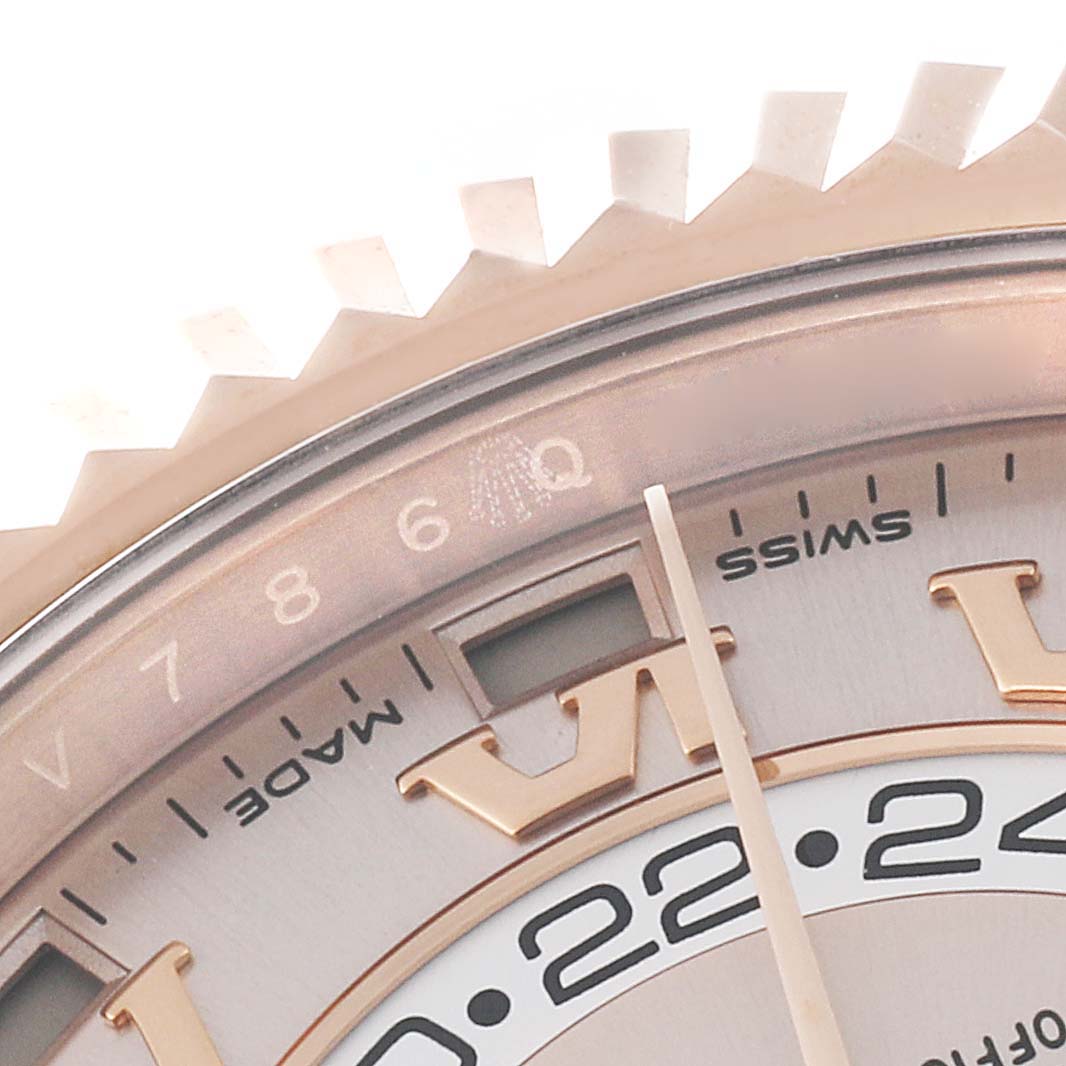 This image shows a close-up of the bezel and part of the dial of a Rolex Sky-Dweller 326935 Men's Rose Gold Pink Dial 326935 Men's Rose Gold Pink Dial watch.