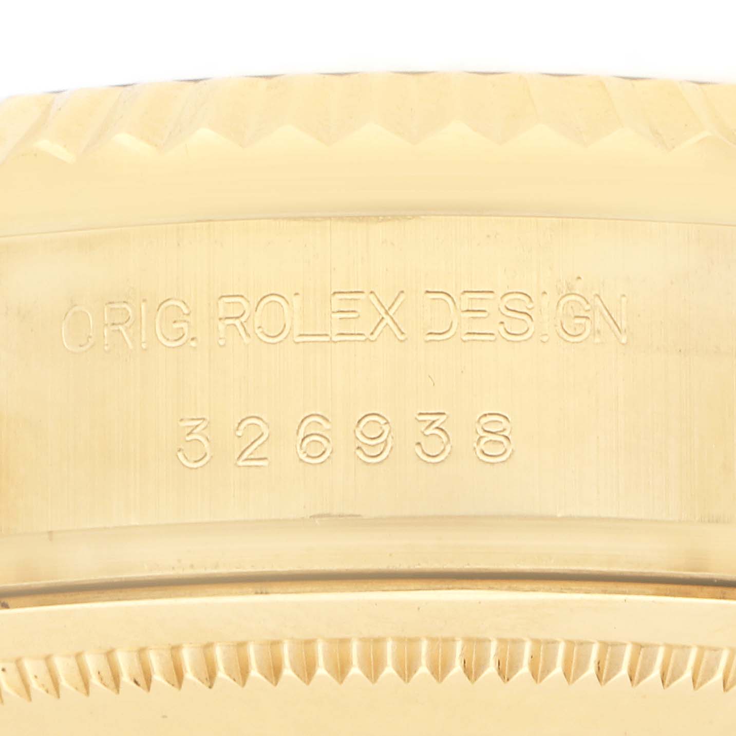 The image shows a close-up of the side of the Rolex Sky-Dweller 326938 Men's Yellow Gold Champagne Dial's case, highlighting the original design engraving and model number.