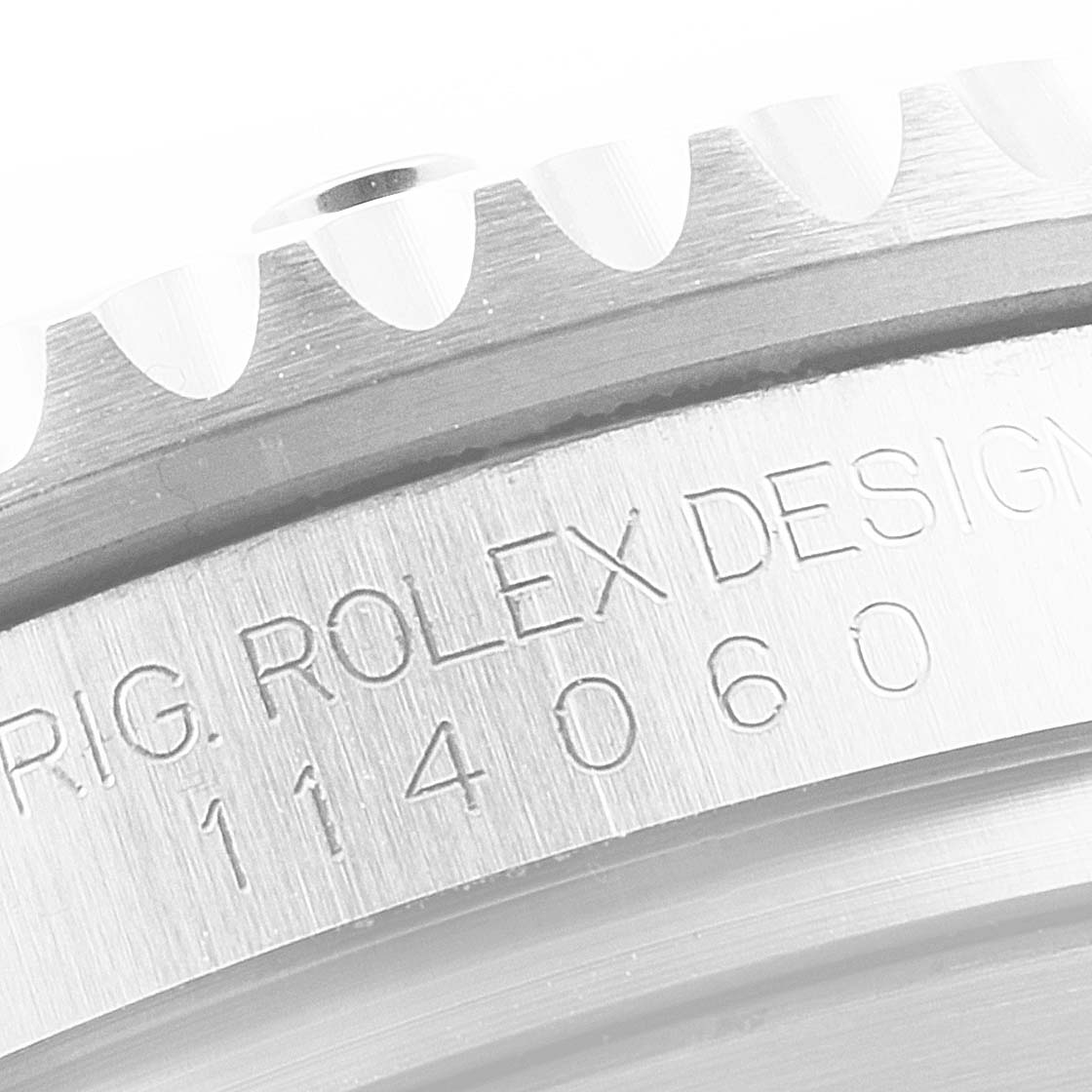 This image shows a close-up of the engraved side and bezel of a Rolex Submariner 114060 Men
s Stainless Steel Black Dial 114060 Men
s Stainless Steel Black Dial watch.