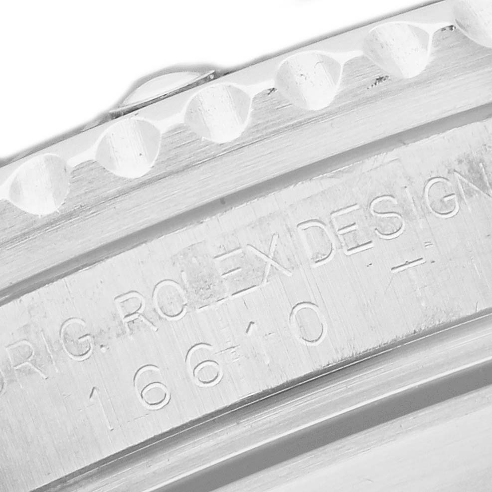 The image shows a close-up of the Rolex Submariner 16610 Men's Stainless Steel Black Dial's case edge with engraved model details.