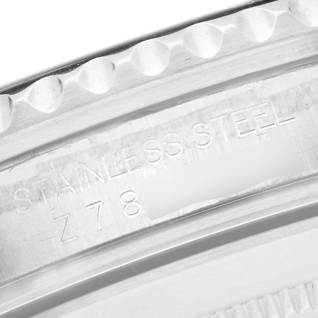 The image shows a close-up of the side of a Rolex Submariner 16610 Men's Stainless Steel Black Dial's stainless steel case with engraving visible.