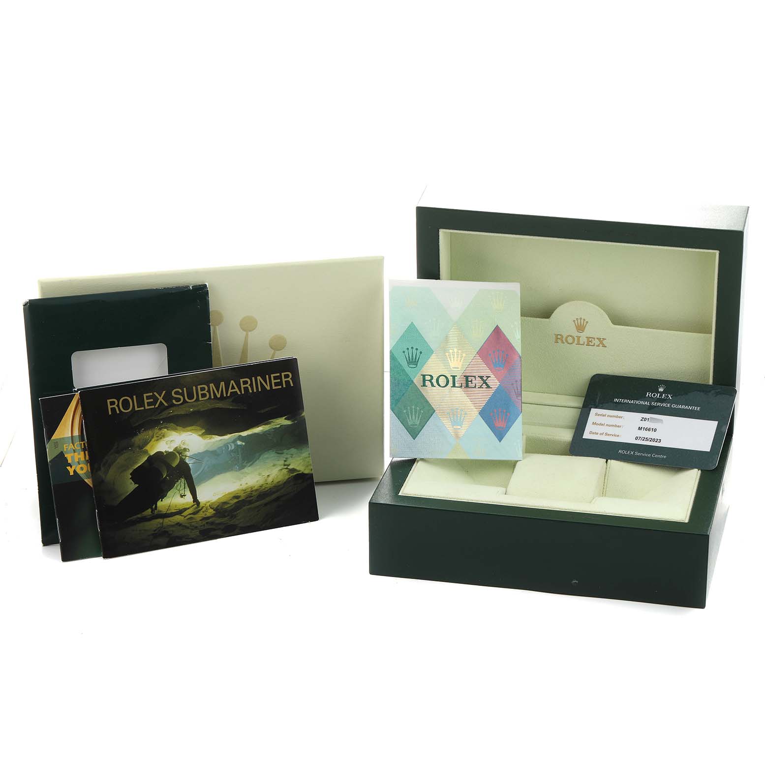 The image shows a Rolex Submariner 16610 Men's Stainless Steel Black Dial box, manuals, and a service guarantee card from a front angle.