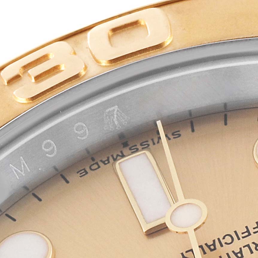 The image shows a close-up of the dial and bezel of a Rolex Yacht-Master 16623 Men's Steel and Gold (two tone) Champagne Dial 16623 Men's Steel and Gold (two tone) Champagne Dial watch, highlighting the numerals and part of the face.