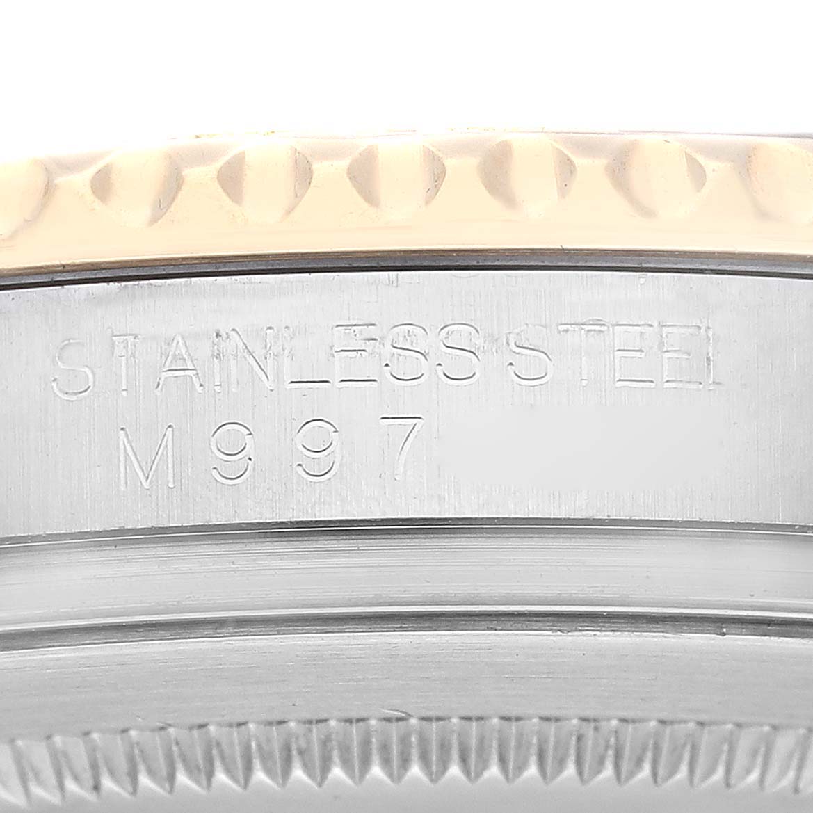 This close-up image shows the stainless steel case side with engraved text on the Rolex Yacht-Master 16623 Men's Steel and Gold (two tone) Champagne Dial 16623 Men's Steel and Gold (two tone) Champagne Dial watch.