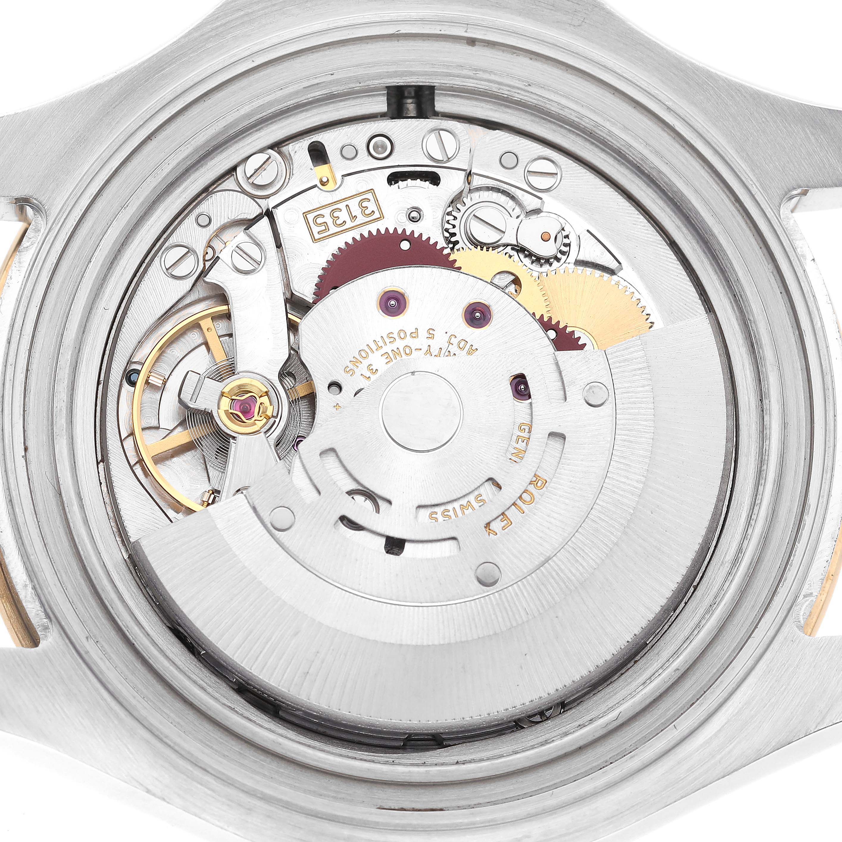The image shows an internal view of the Rolex Yacht-Master 16623 Men's Steel and Gold (two tone) Champagne Dial 16623 Men's Steel and Gold (two tone) Champagne Dial watch movement with gears, the balance wheel, and the rotor visible.