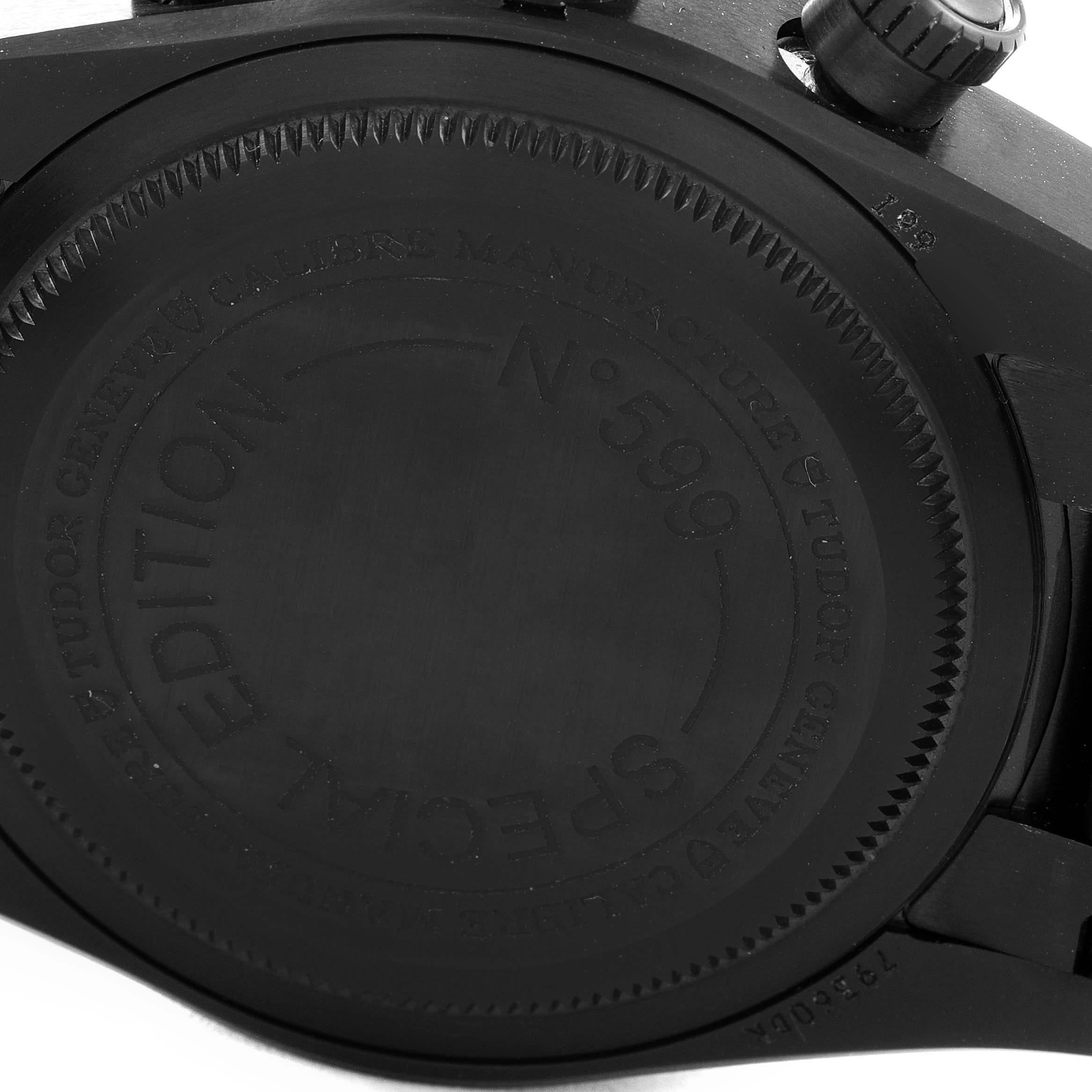 The image shows the back case and part of the crown of a Heritage Black Bay model by Tudor.