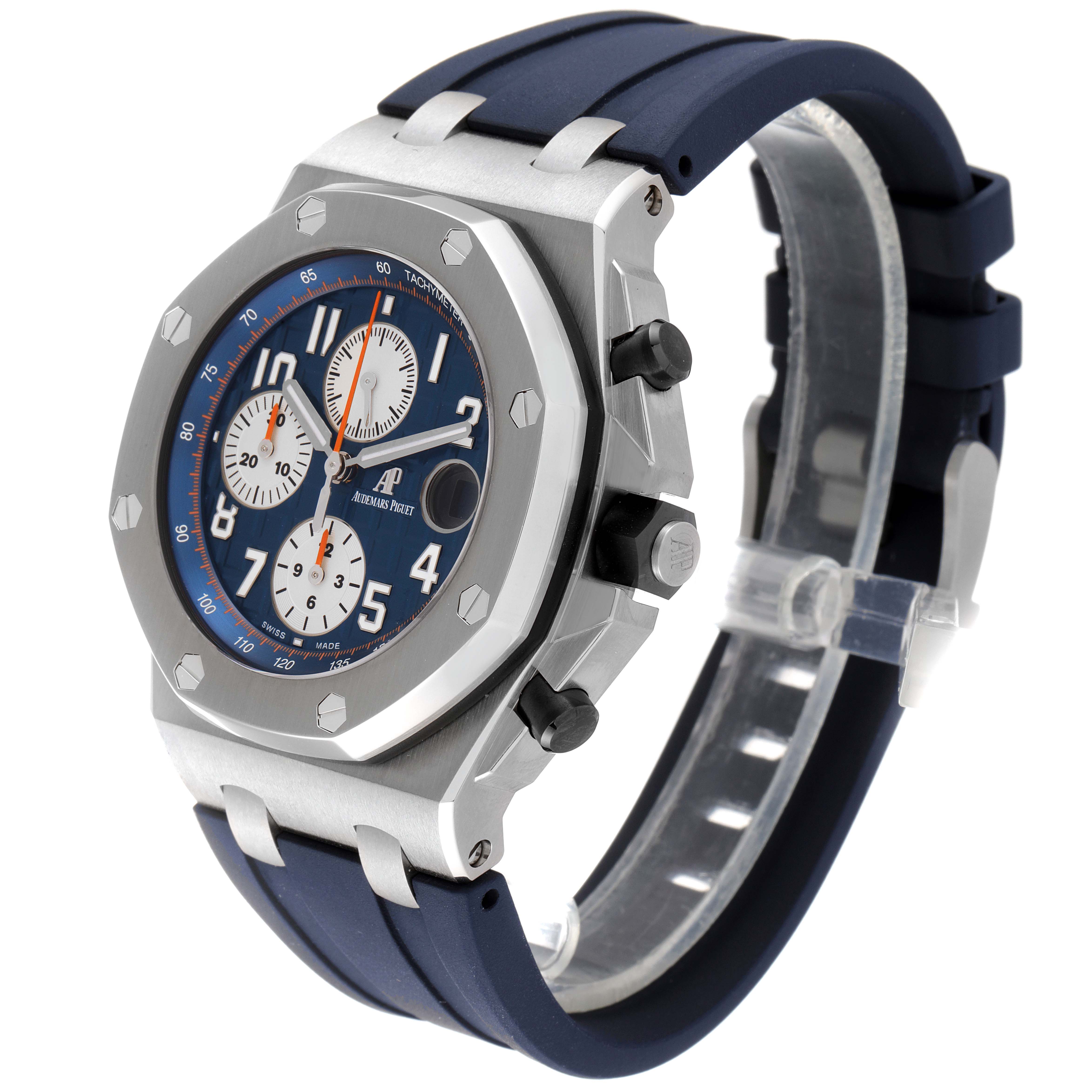 The image shows a Royal Oak Offshore by Audemars Piguet at a 3/4 angle, highlighting its blue dial, silver case, and blue strap.