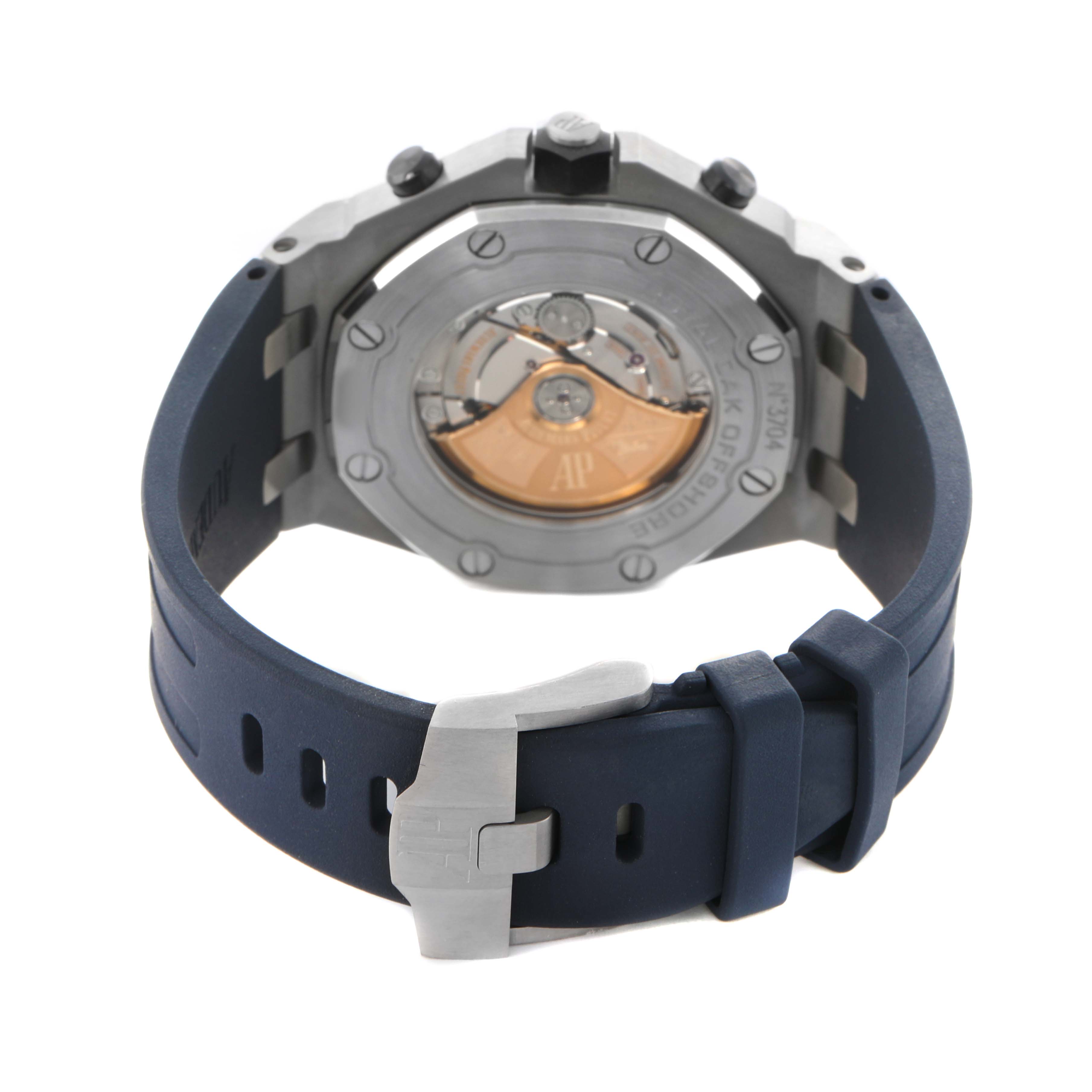 The image shows the back view of an Audemars Piguet Royal Oak Offshore 26470ST.OO.A027CA.01 Men's Stainless Steel Blue Dial watch, highlighting the case back and rubber strap with a buckle.