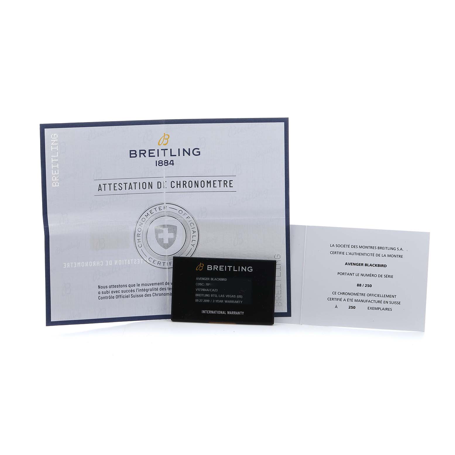 The image shows documents and a warranty card for the Breitling Avenger V17310A/CA23 Men's Titanium Blue Dial model, featuring certification details.