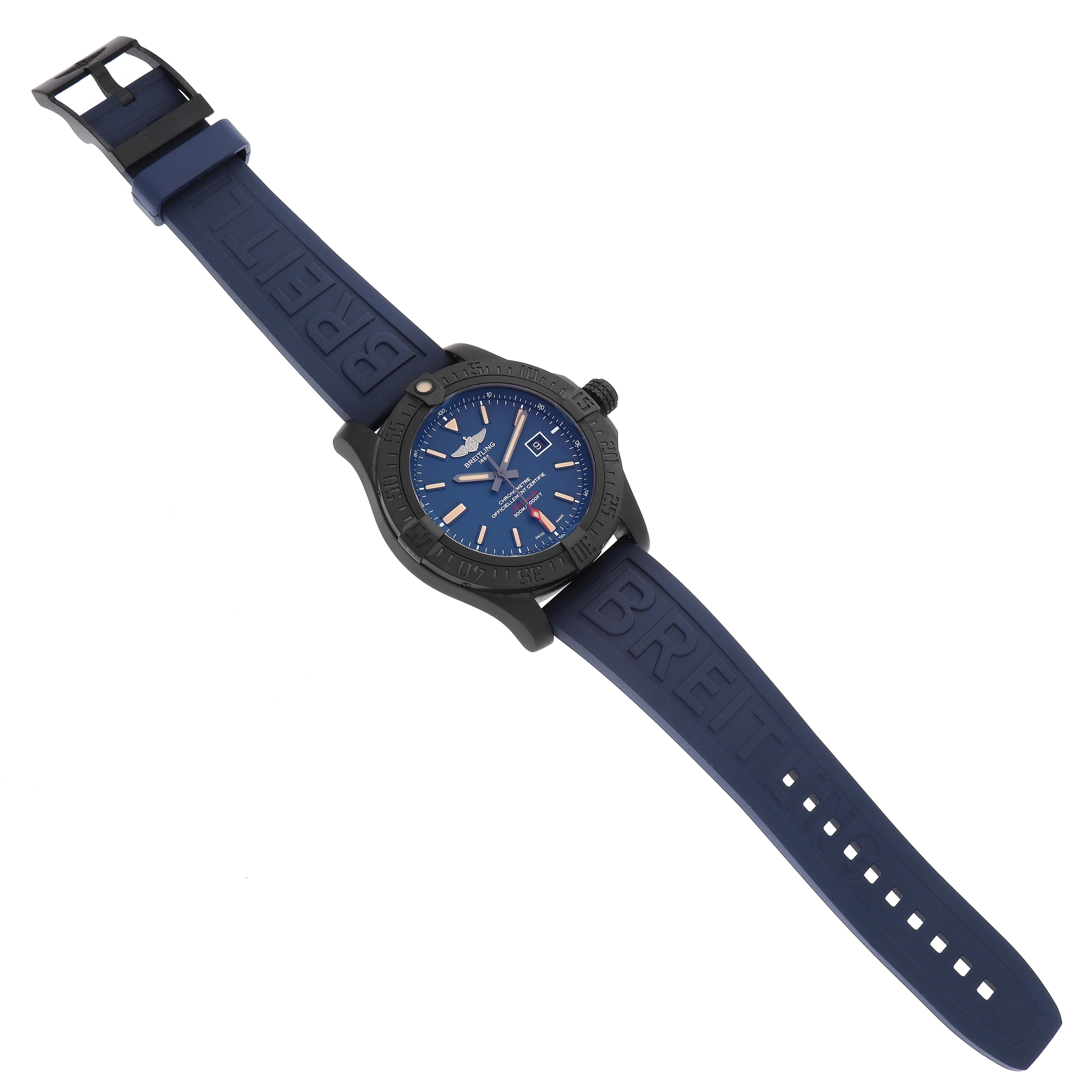 The Breitling Avenger V17310A/CA23 Men's Titanium Blue Dial watch is shown at an angled top view, highlighting its blue dial, black case, and blue rubber strap.