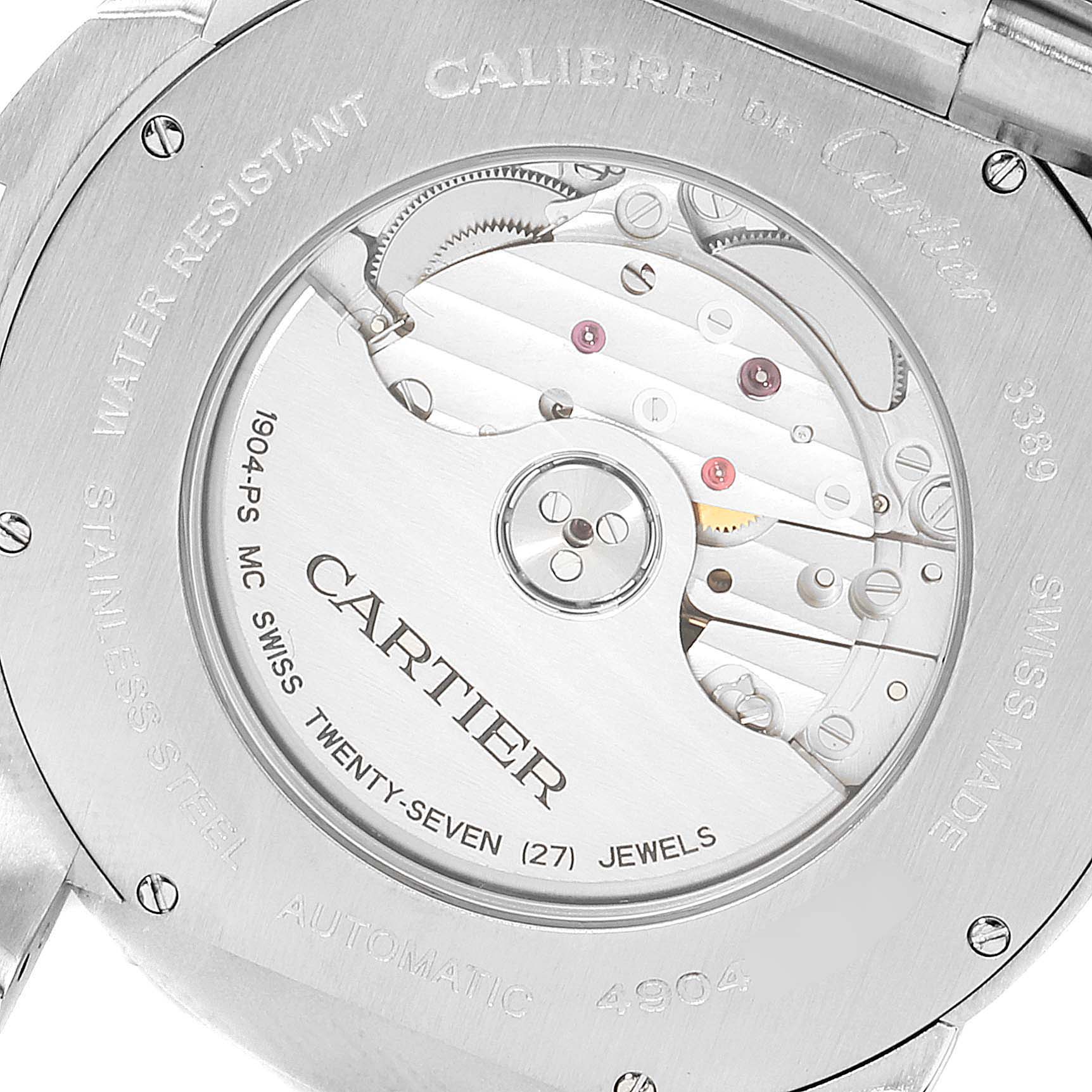 The image shows the back of a Calibre de Cartier watch, displaying the movement and "Cartier" engraving.