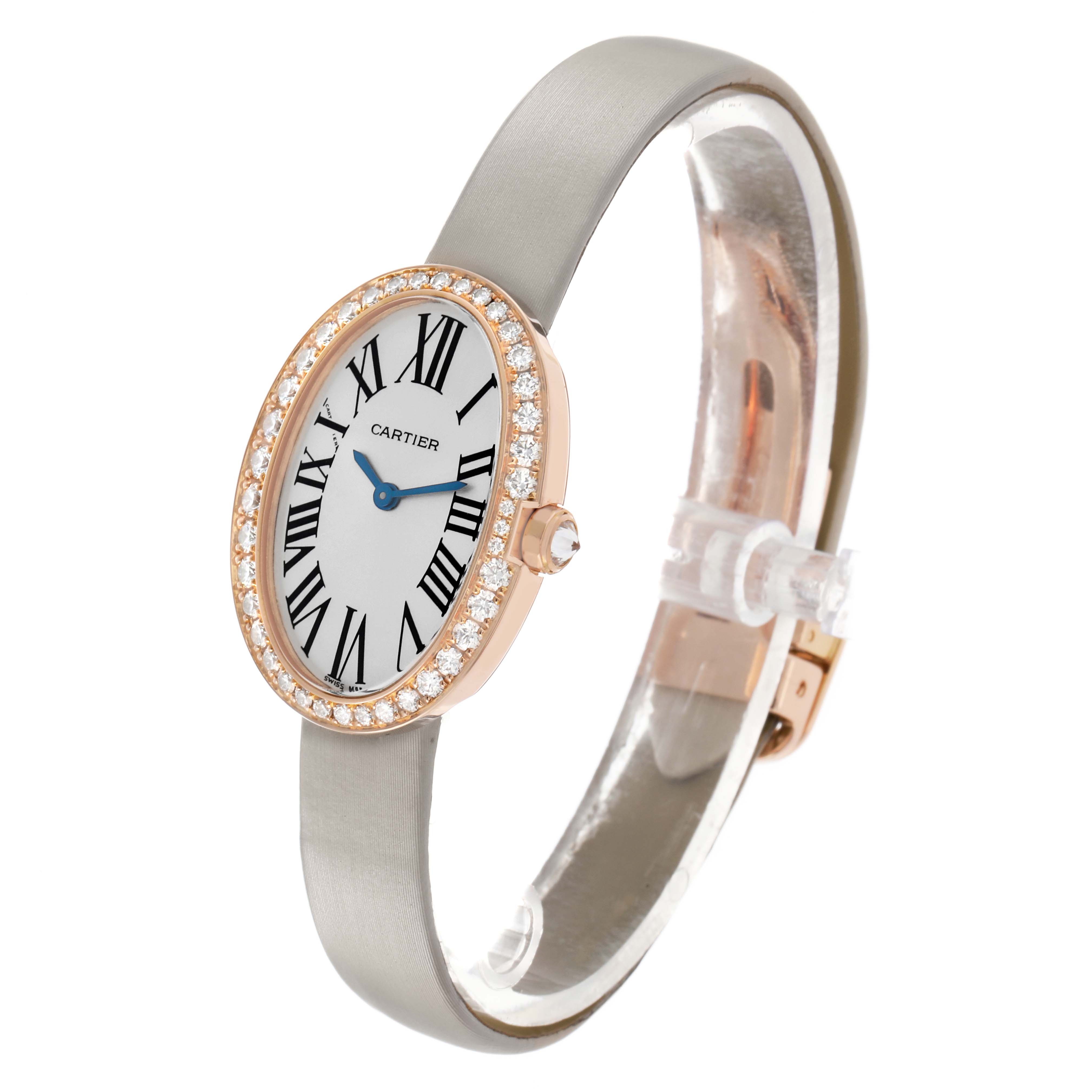 The Cartier Baignoire WB520004 Women's Rose Gold Silver Dial watch is shown from a front-side angle, displaying the oval face, diamond bezel, strap, and crown.