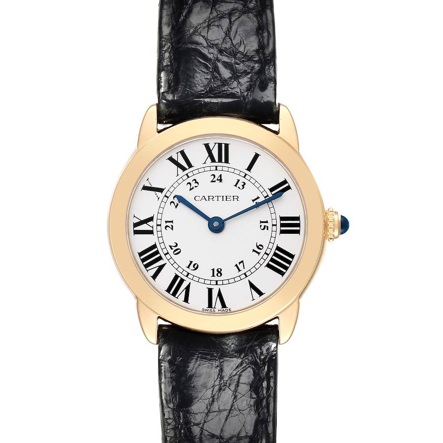 The Cartier Ronde watch is shown from a top-down angle, displaying the face, Roman numerals, and leather strap.