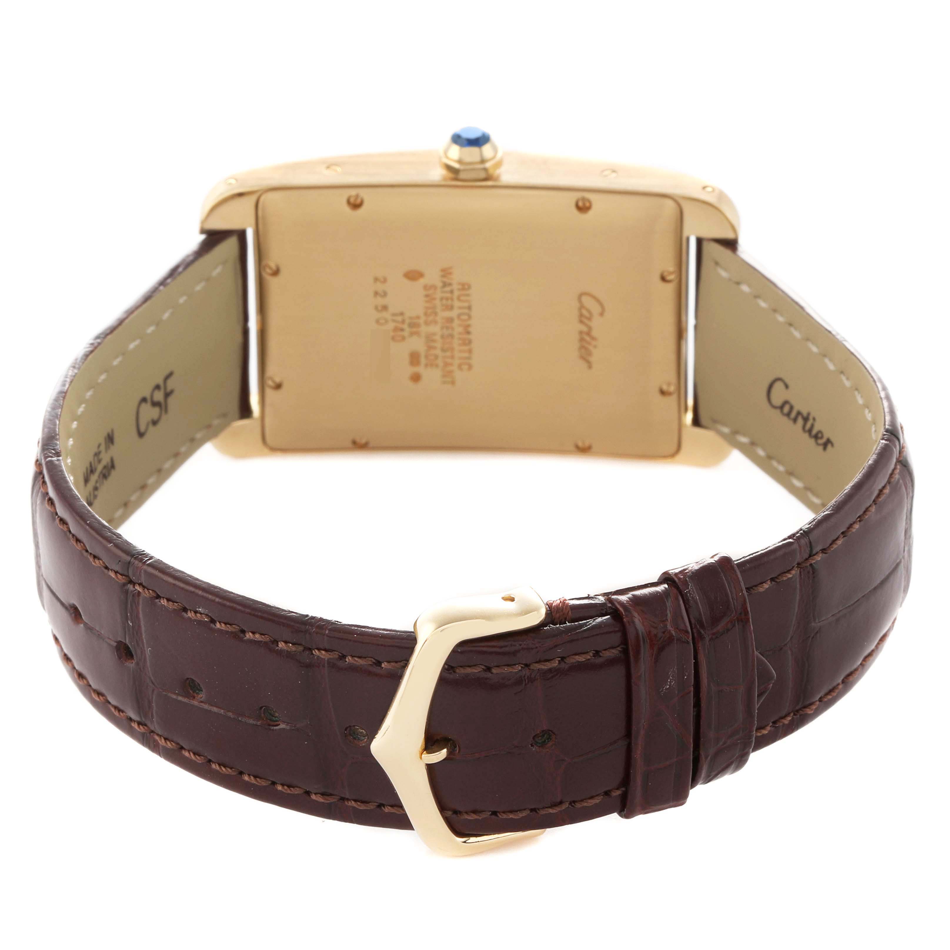 The Cartier Tank Americaine W2603156 Men's Yellow Gold Silver Dial watch is shown from the back, highlighting its case back, leather strap, and buckle.