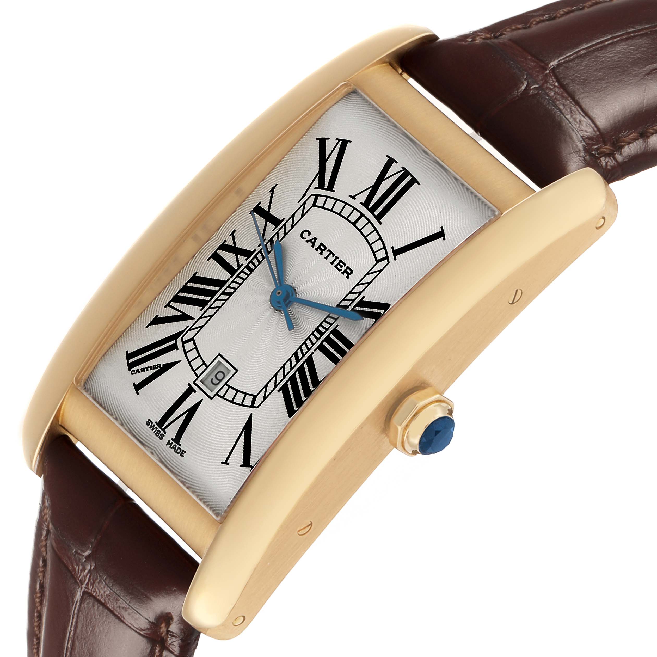 The Cartier Tank Américaine watch is shown at a slight angle, featuring the dial, Roman numerals, and a leather strap.