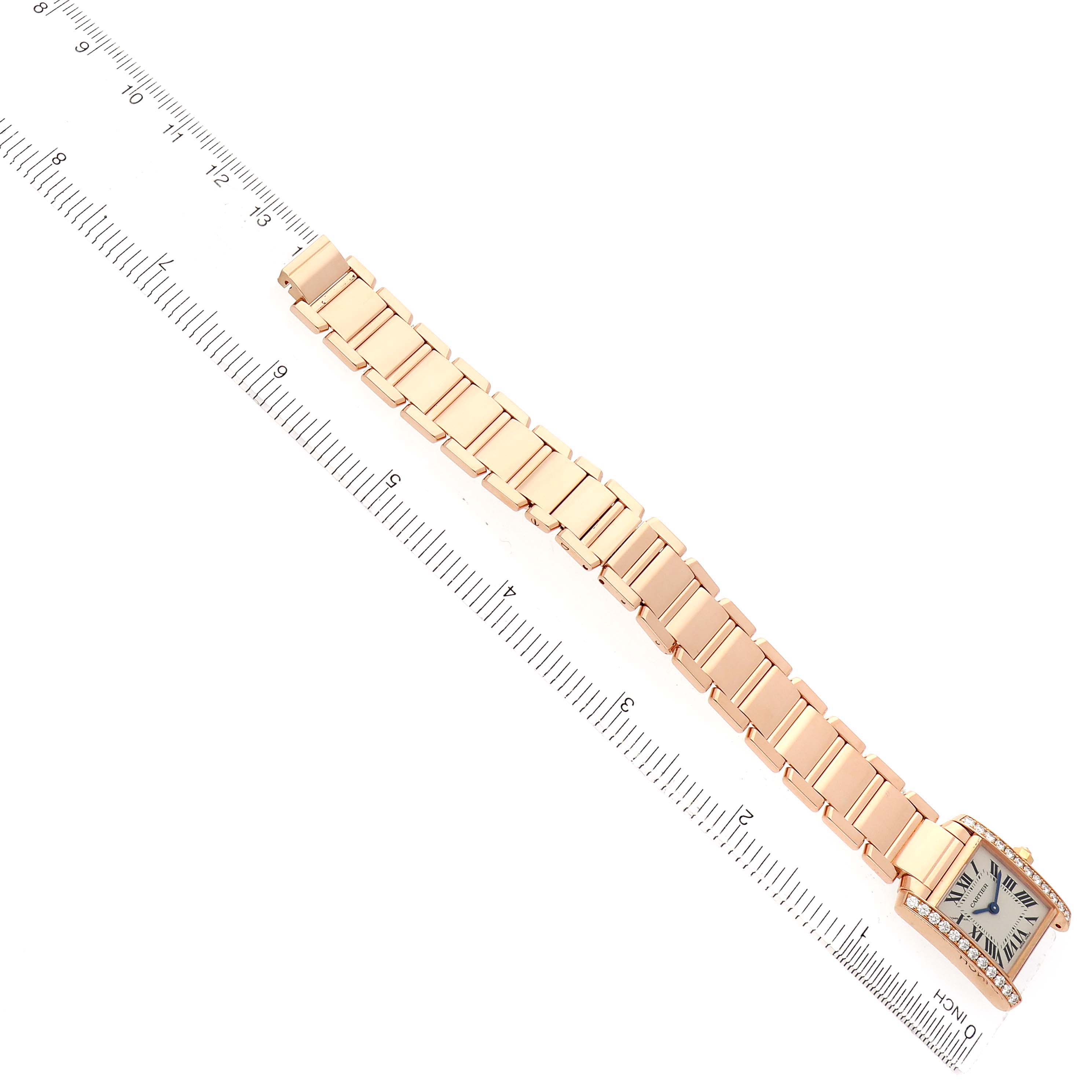 The Cartier Tank Francaise WE10456H Women's Rose Gold Silver Dial watch is shown from an angled top view, displaying the face and full bracelet against a ruler.