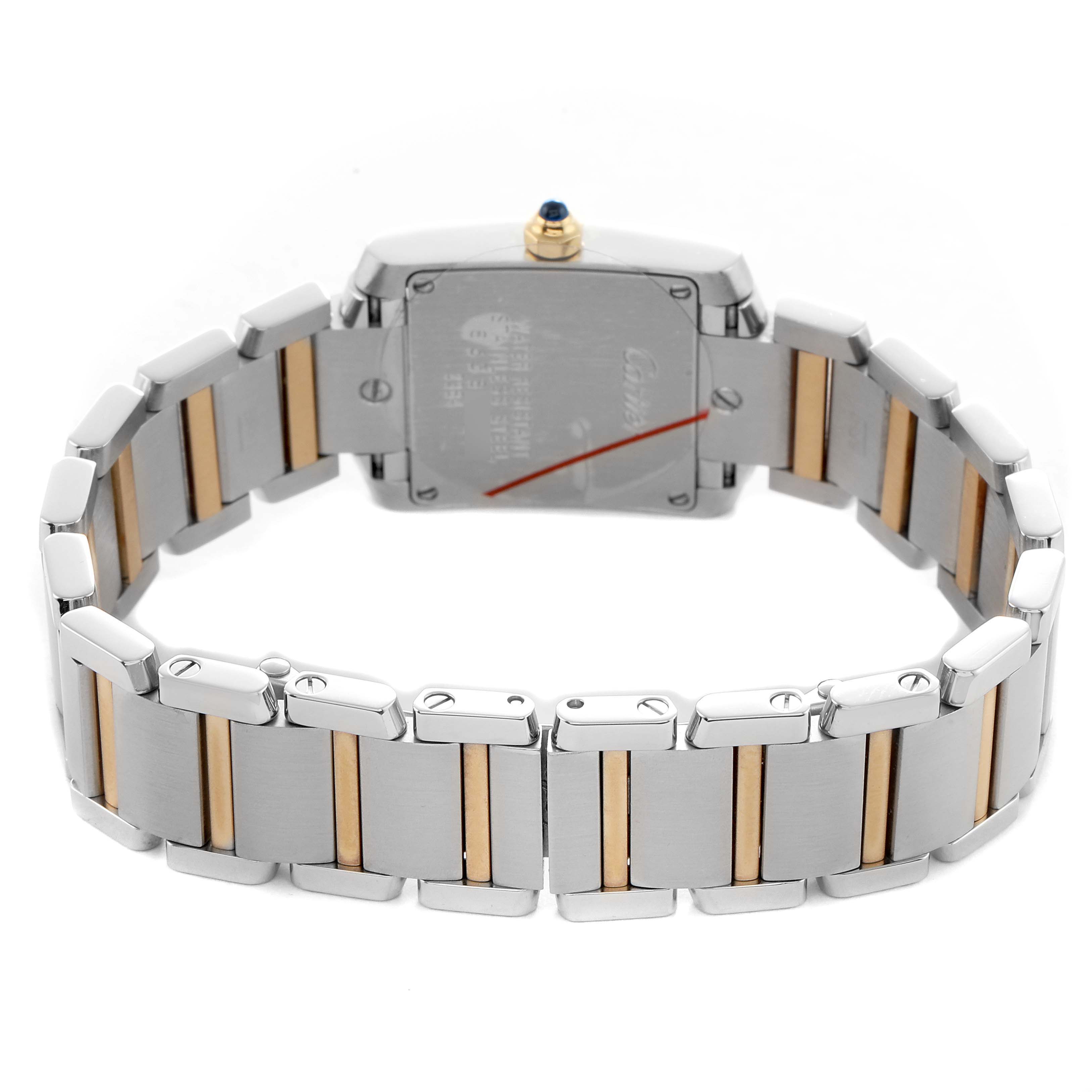 The Cartier Tank Française watch is shown from the back, highlighting its stainless steel and gold bracelet.