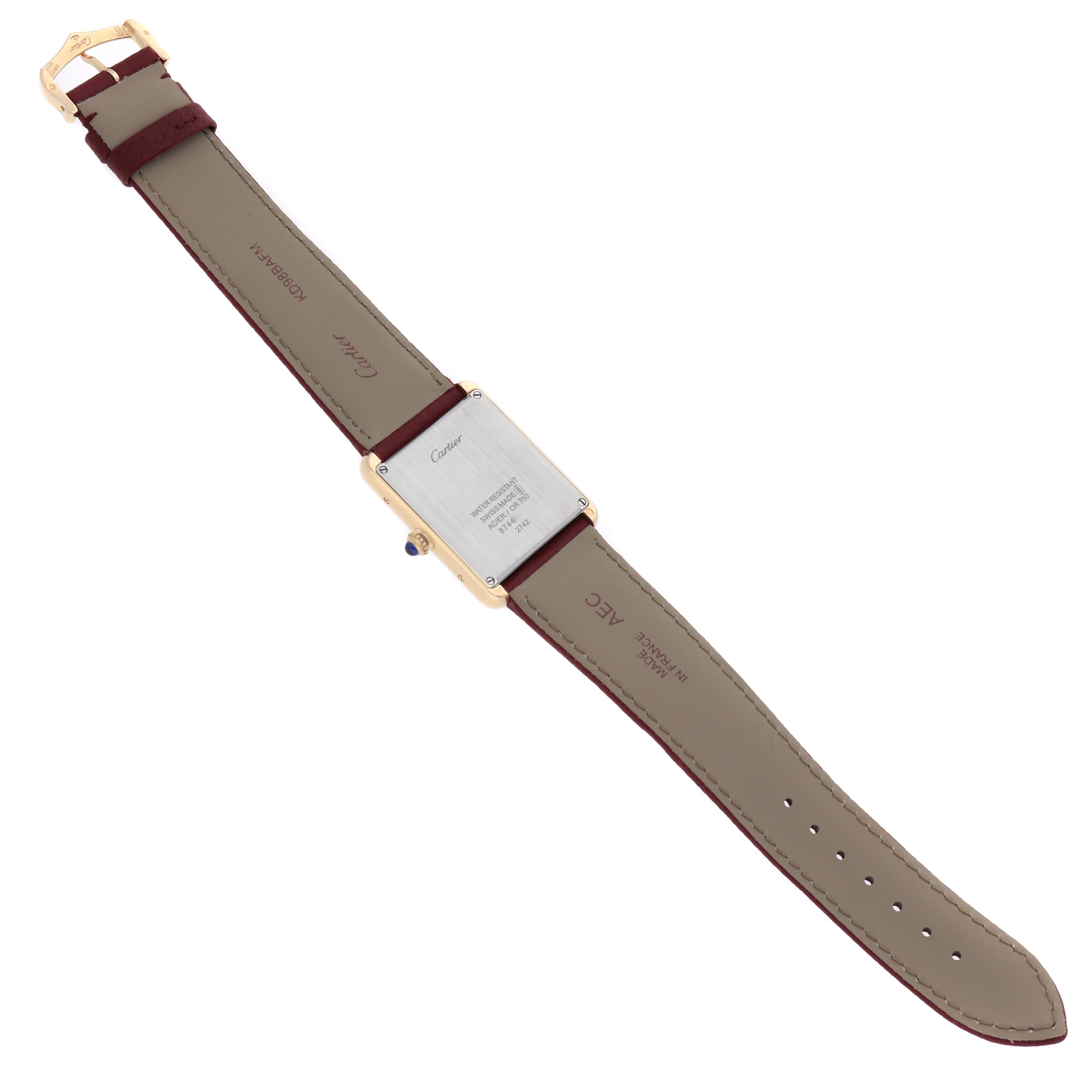 The Cartier Tank Solo W1018855 Men's Yellow Gold Silver Dial watch is shown from the back, displaying the case back and the leather strap with its clasp.