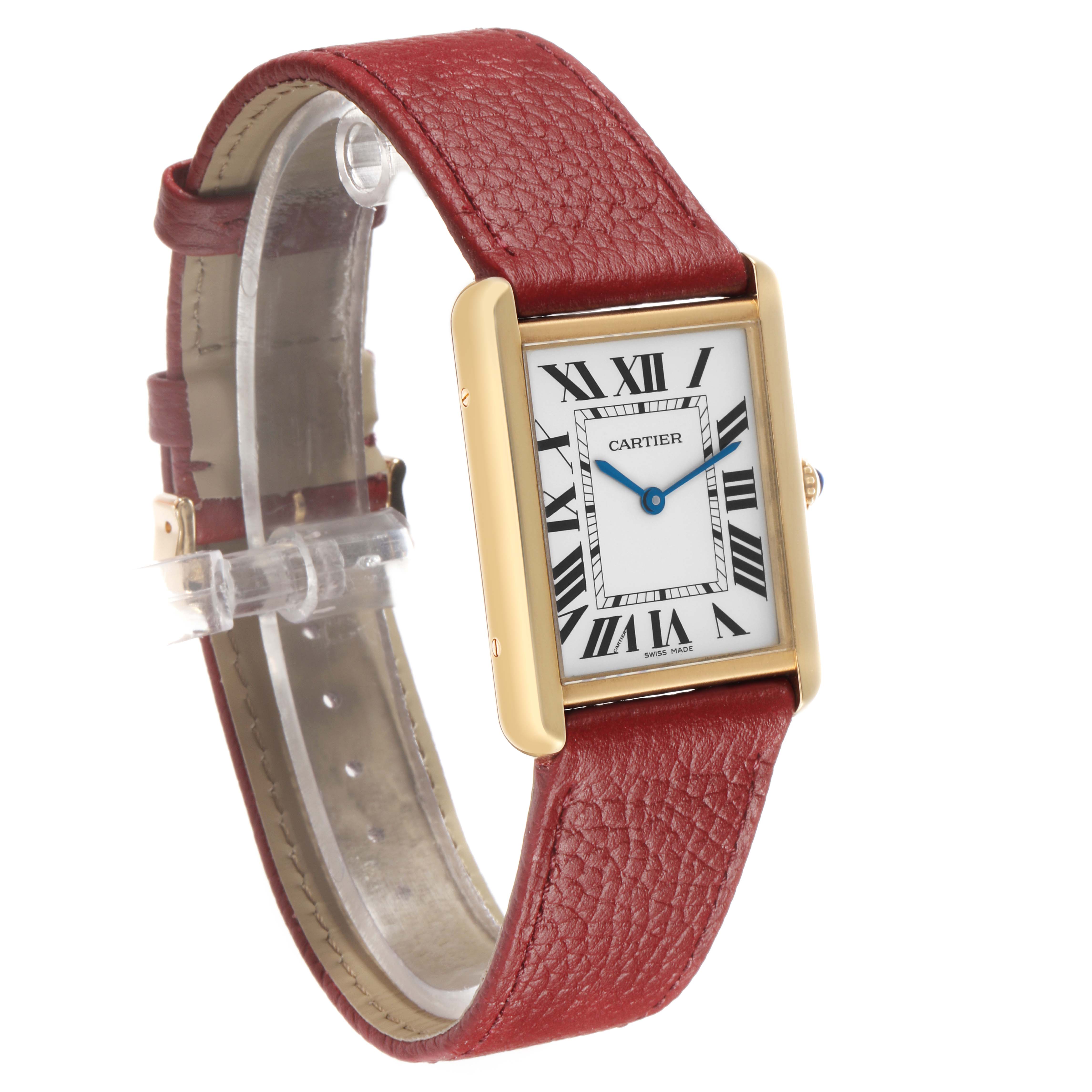 The Cartier Tank Solo W1018855 Men's Yellow Gold Silver Dial watch is angled to show its rectangular face, gold-tone case, blue hands, and red leather strap.