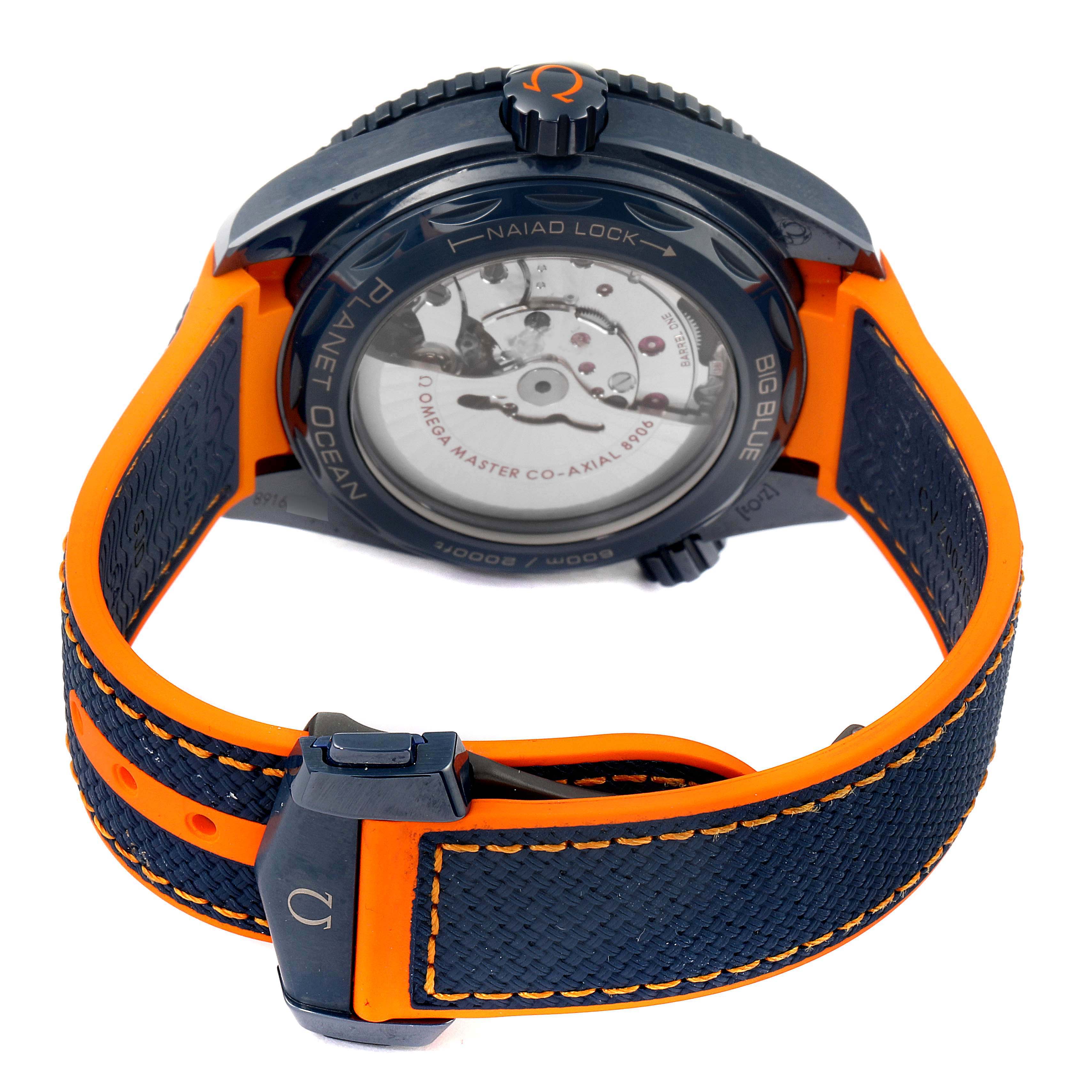 The image shows the back view of an Omega Planet Ocean 215.92.46.22.03.001 Men's Stainless Steel Blue Dial 215.92.46.22.03.001 Men's Stainless Steel Blue Dial watch, highlighting its movement, strap, and clasp.