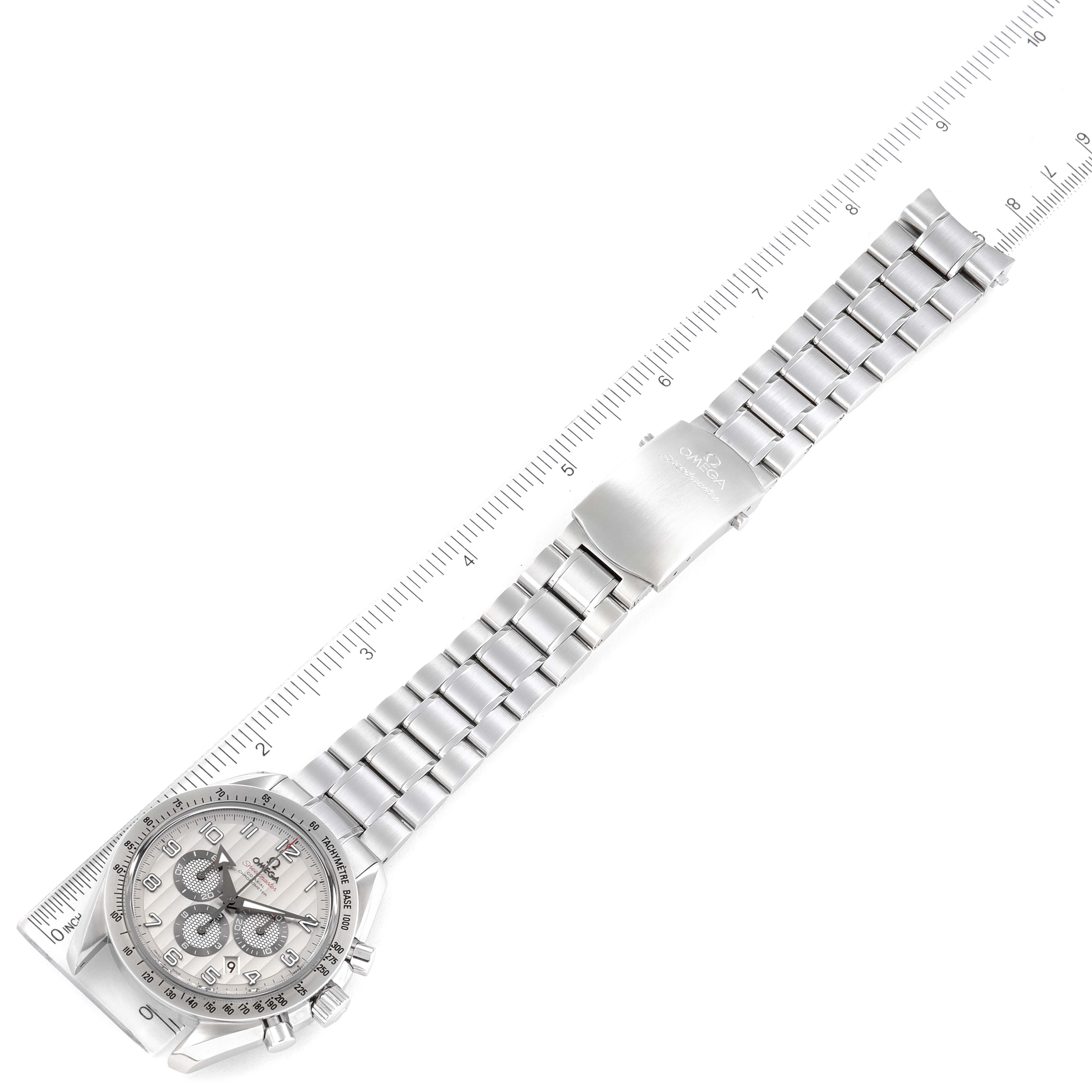 The image shows an Omega Speedmaster 321.10.44.50.02.001 Men
s Stainless Steel Silver Dial 321.10.44.50.02.001 Men
s Stainless Steel Silver Dial wristwatch laid flat with its metal bracelet and clasp fully visible, alongside a ruler for scale.