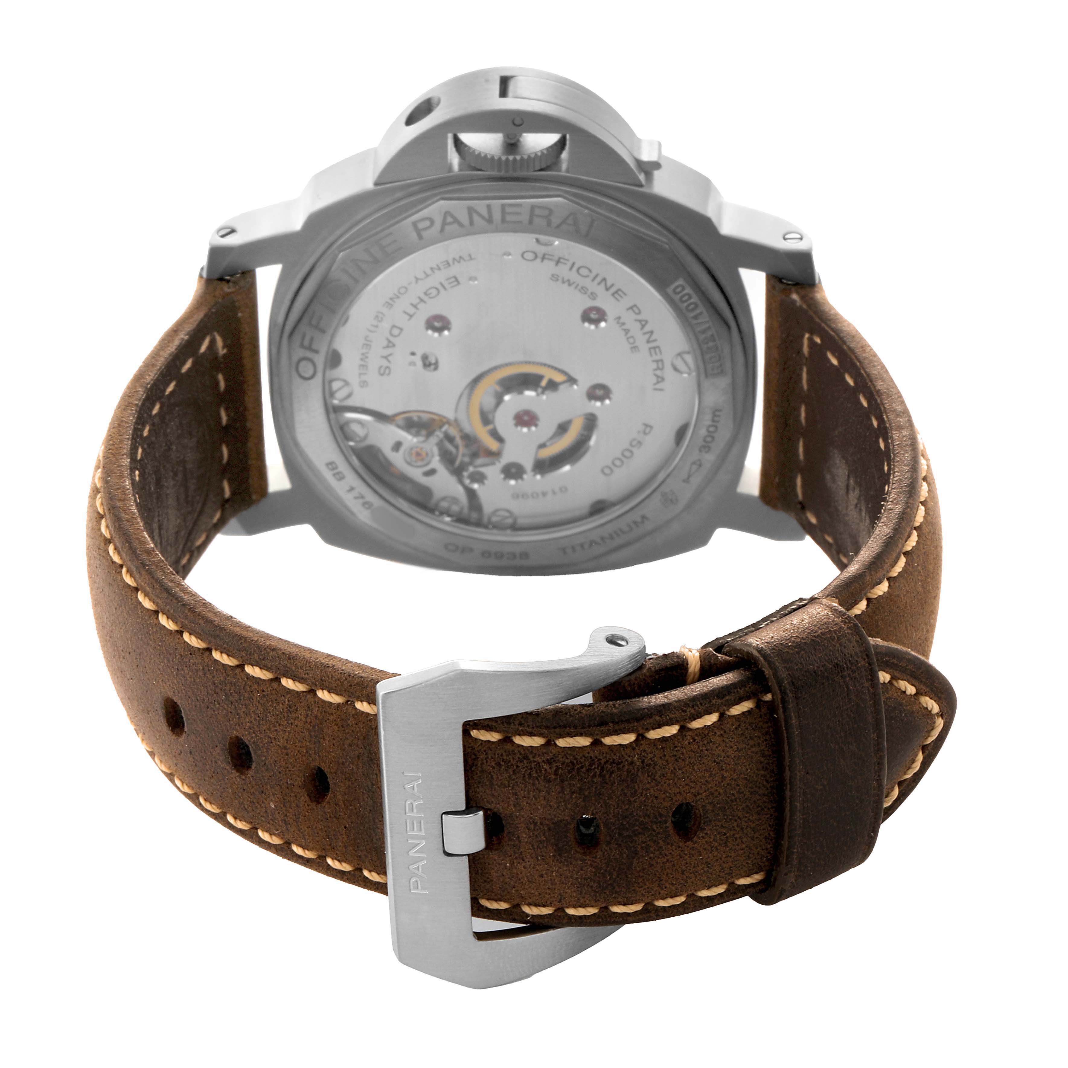 The Panerai Luminor PAM00564 Men's Titanium Black Dial watch is shown from the rear, highlighting its movement and featuring a brown leather strap.